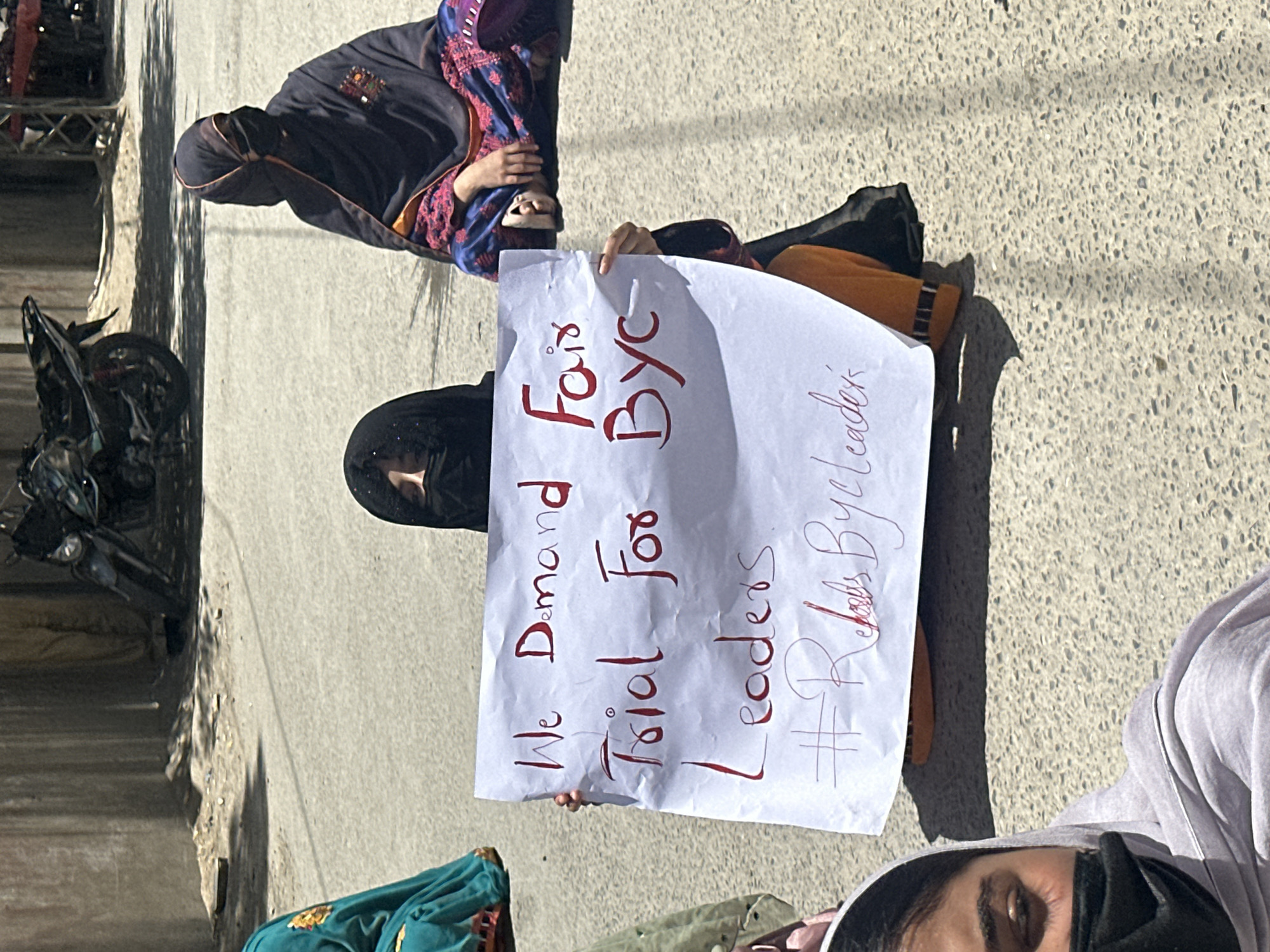 Sit-in protest in Quetta with signs demanding justice