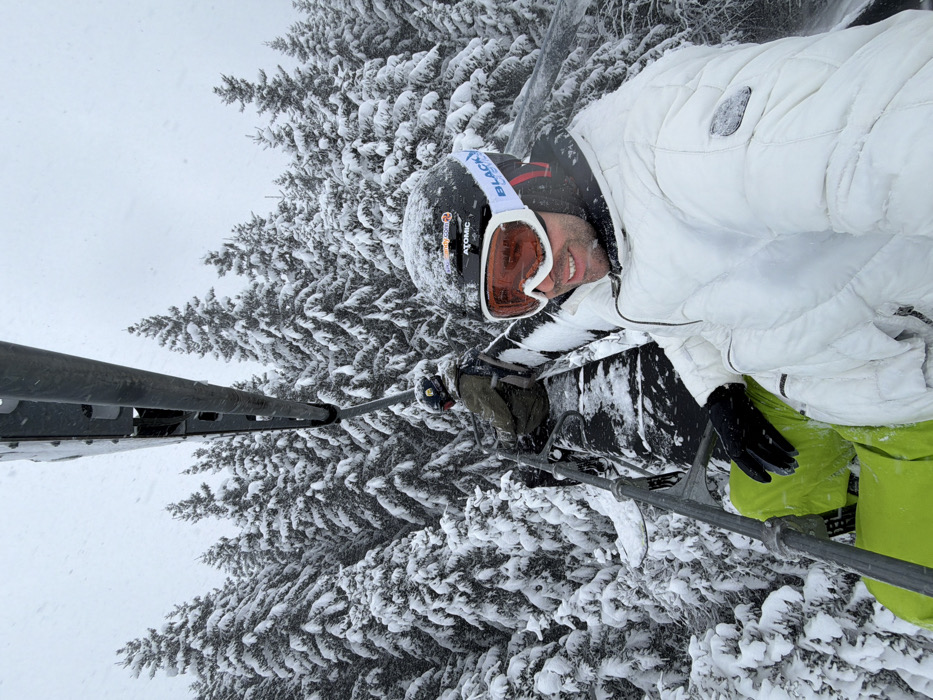 Skier takes selfies on lift during snowfall in Les Allues