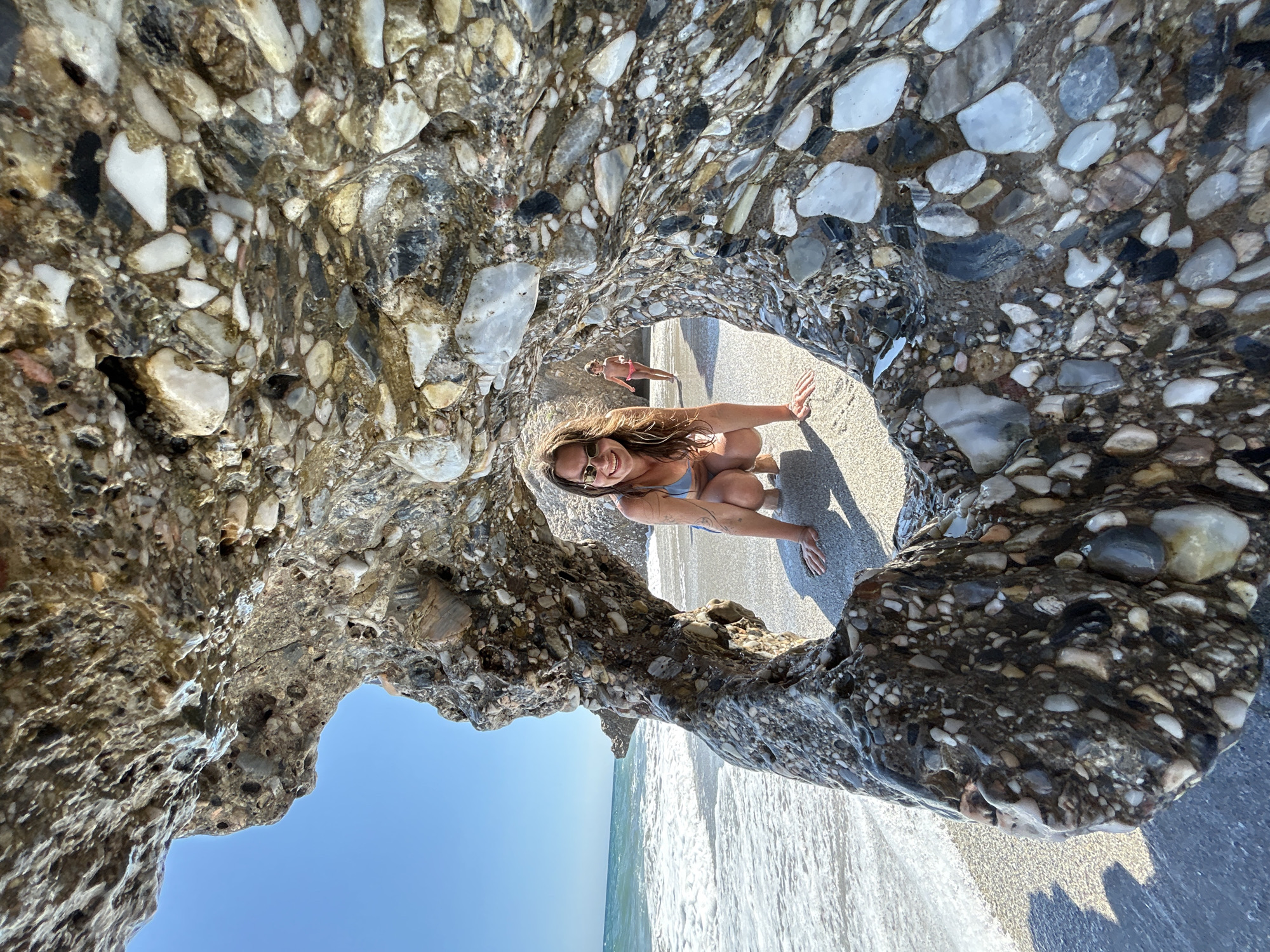 Sunny afternoon at Nerja's rocky, crowded beach