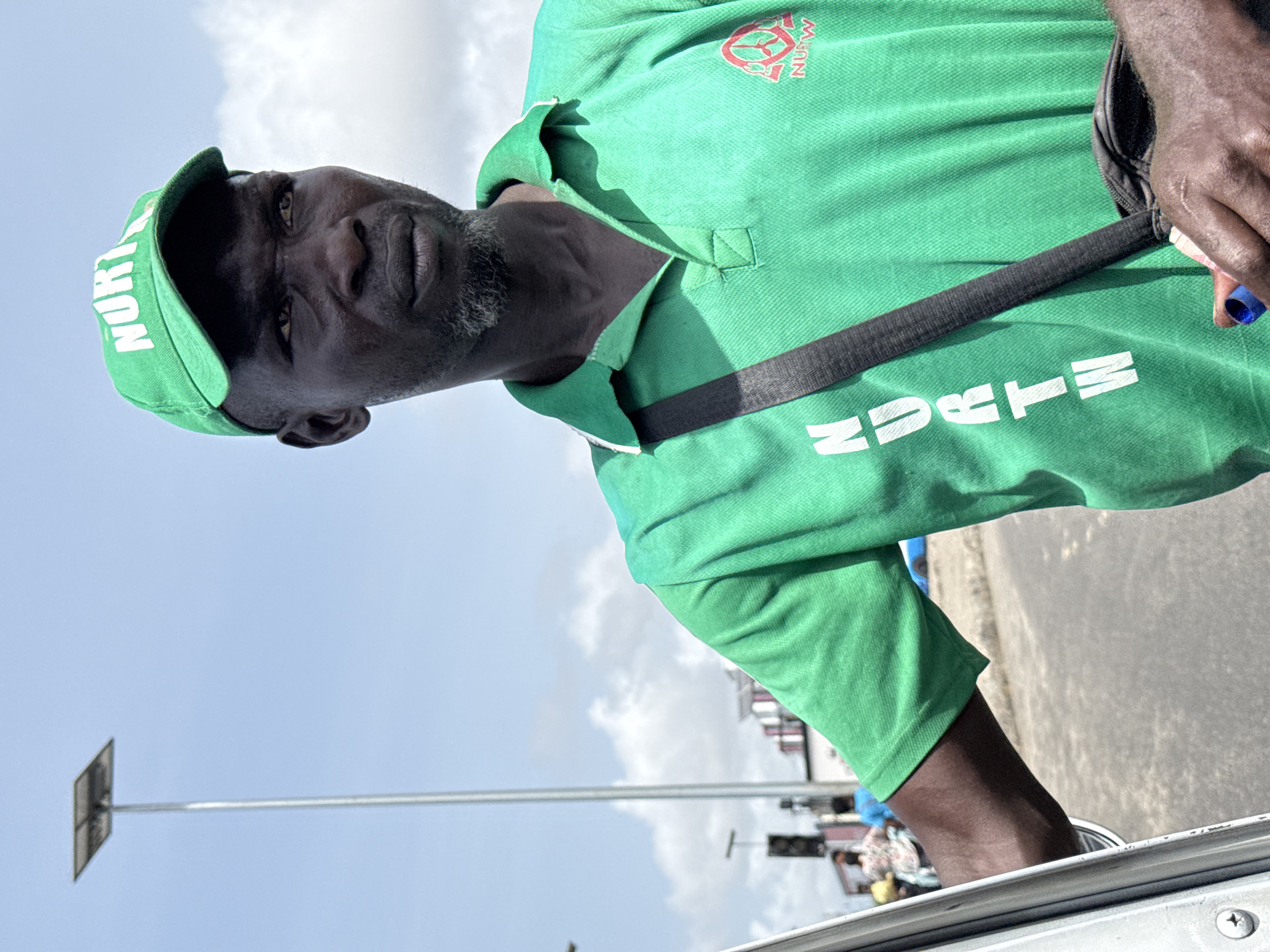 NURTW official photographed in green uniform in Ilado, Nigeria