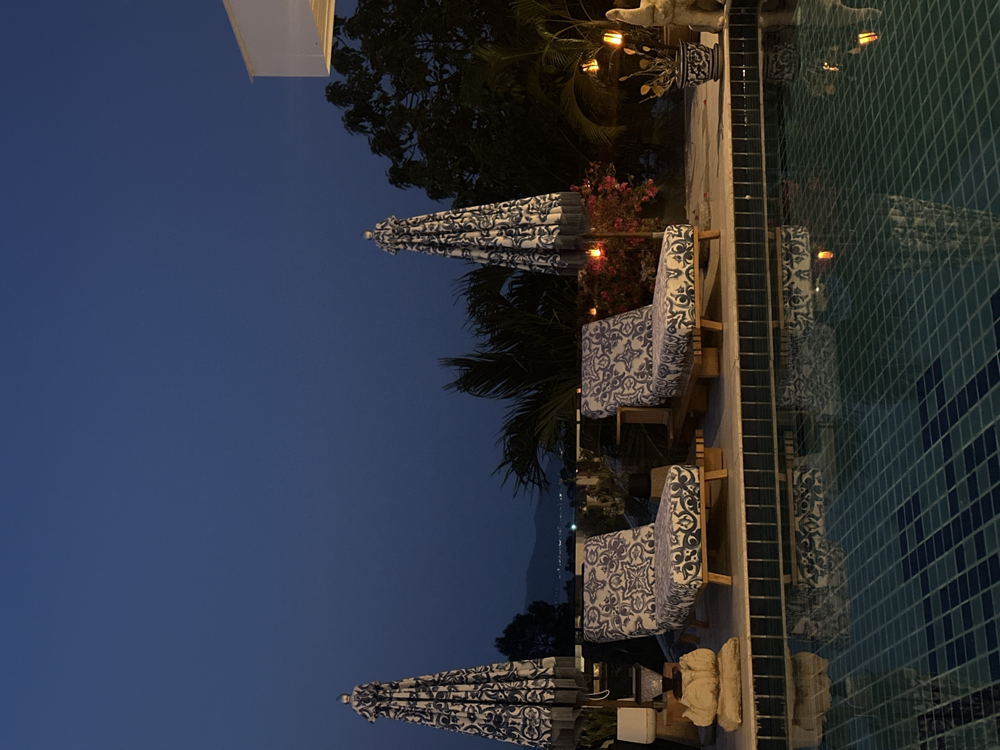 Evening poolside scene and caged monkeys observed in Thailand