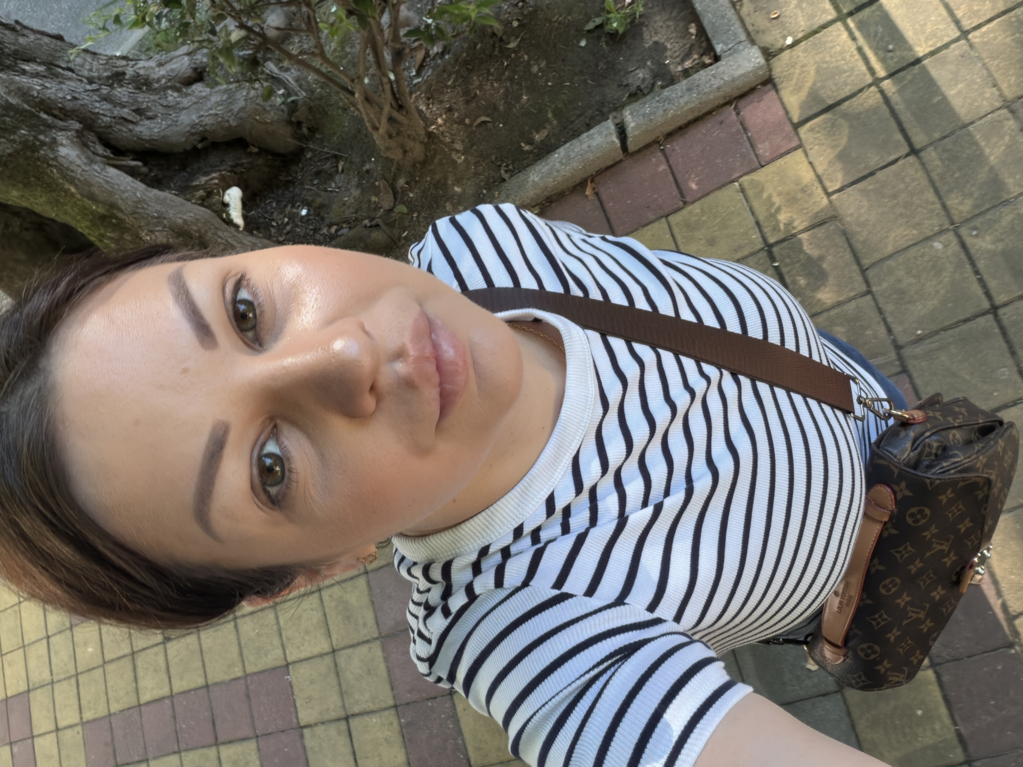 Selfies and street scenes along a sunny Sochi sidewalk