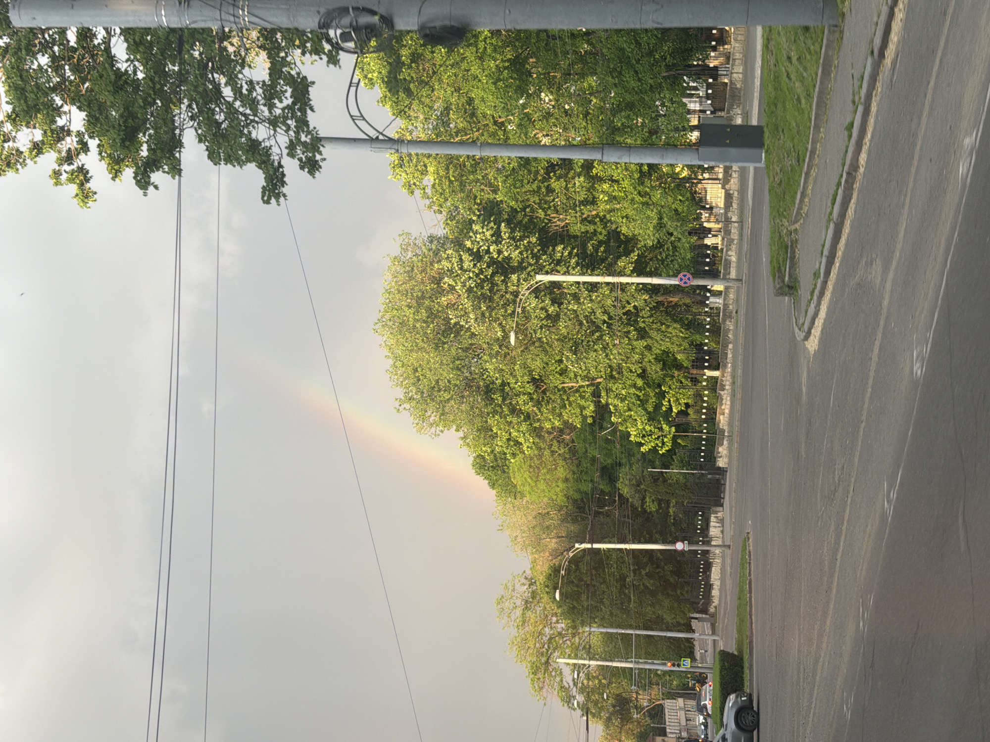 Rainbow appears over residential street in Codru, Moldova