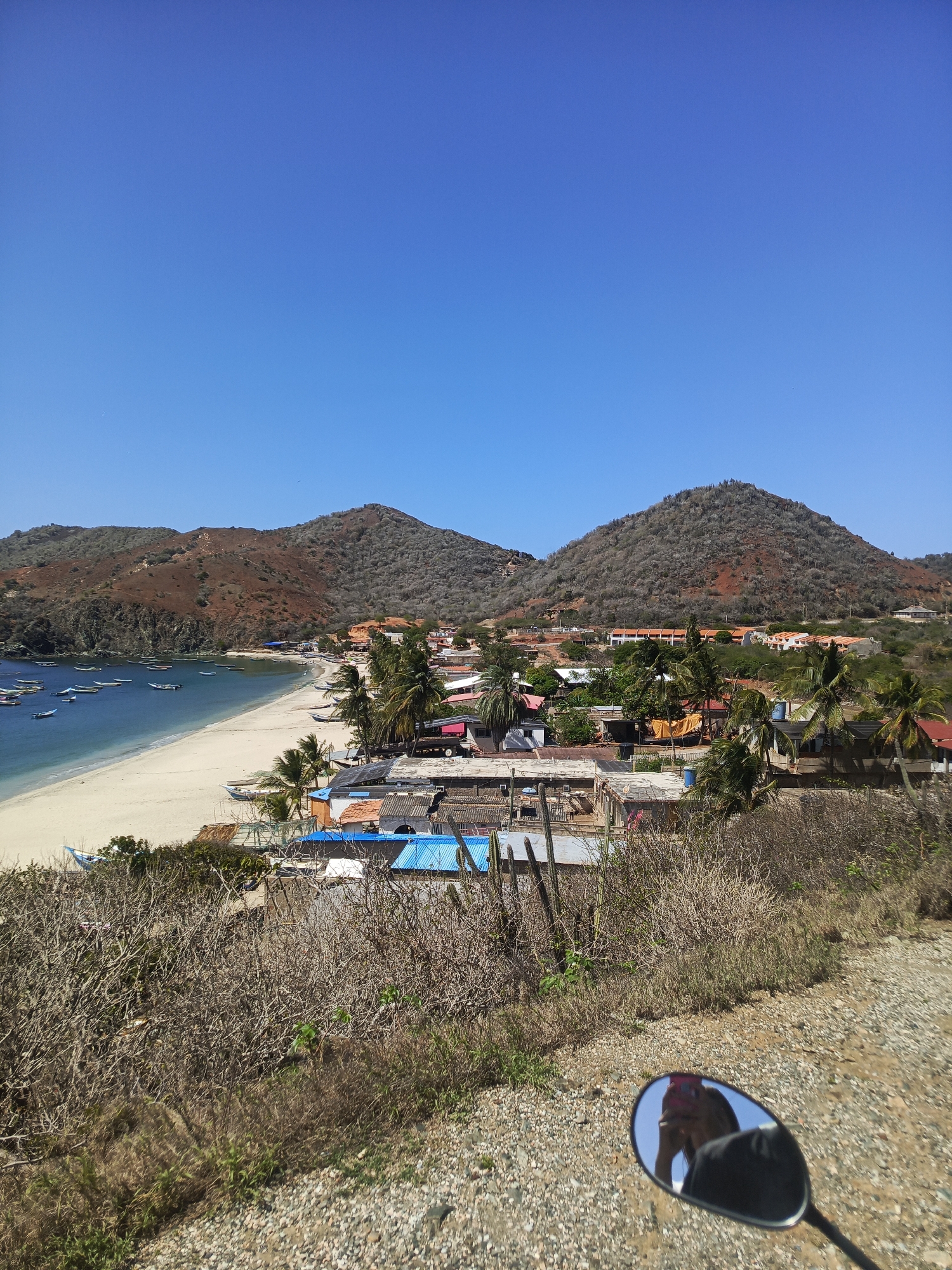 Tourist captures selfies overlooking Venezuelan coastal bays filled with boats