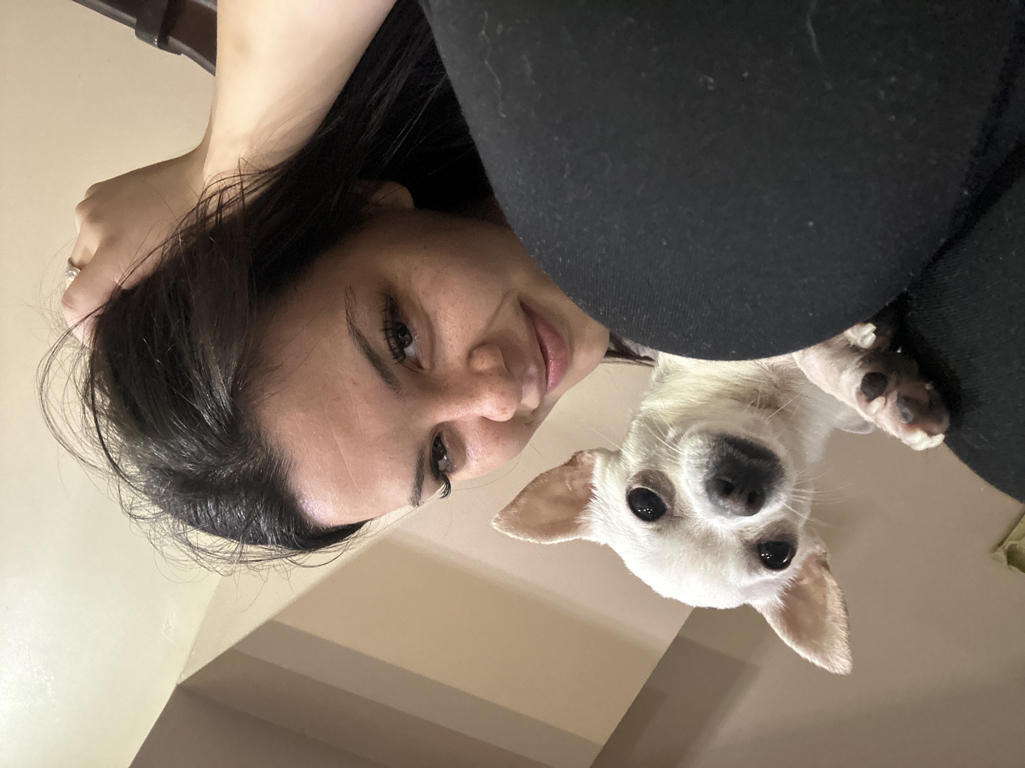 Woman and white Chihuahua photographed in intimate indoor portraits