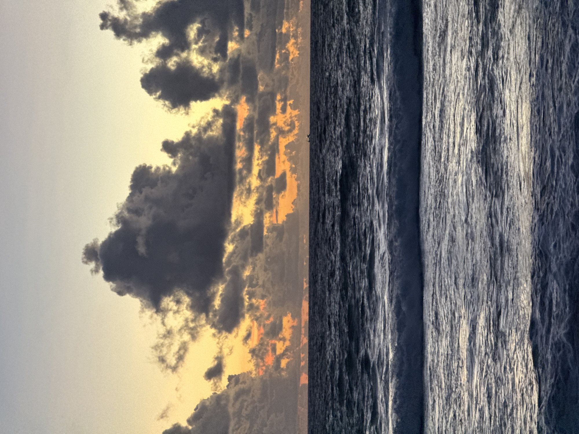 Dramatic sunset sky over a choppy Karon Beach