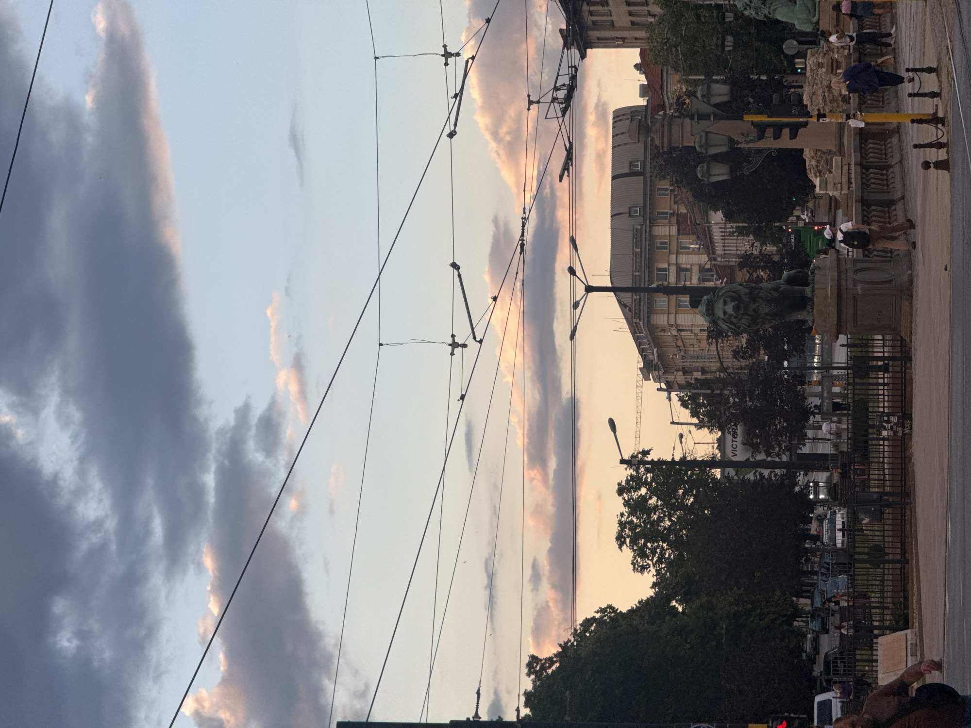 Evening streets of central Sofia, trams, clouds, and city life