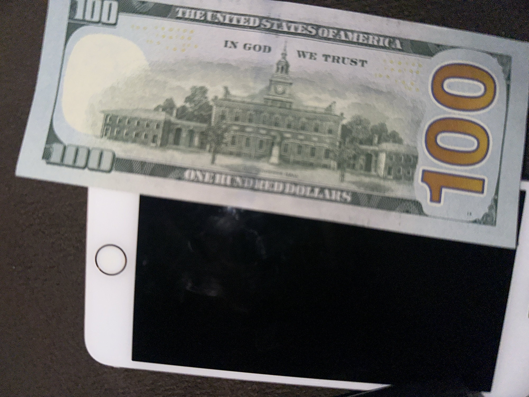 Yerevan witness documents $100 bill with phone and keys