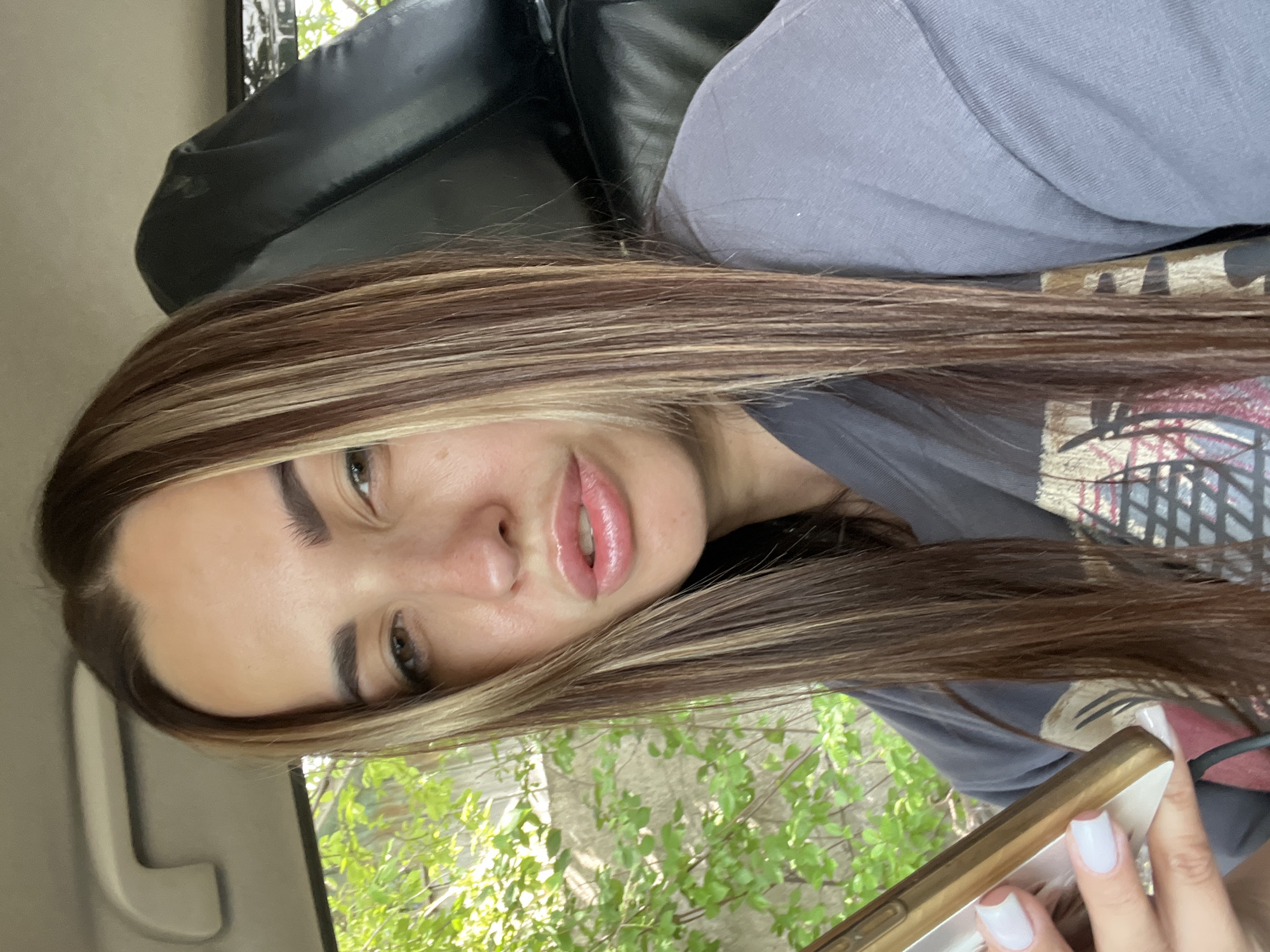 Quick selfie session inside a car, phone in hand