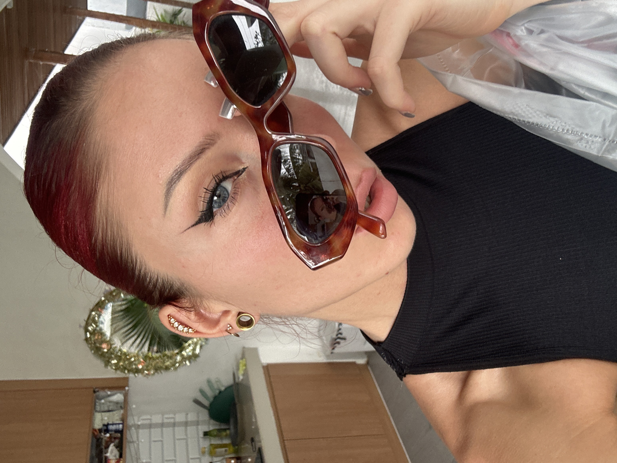 Woman poses with sunglasses indoors in North Kuta