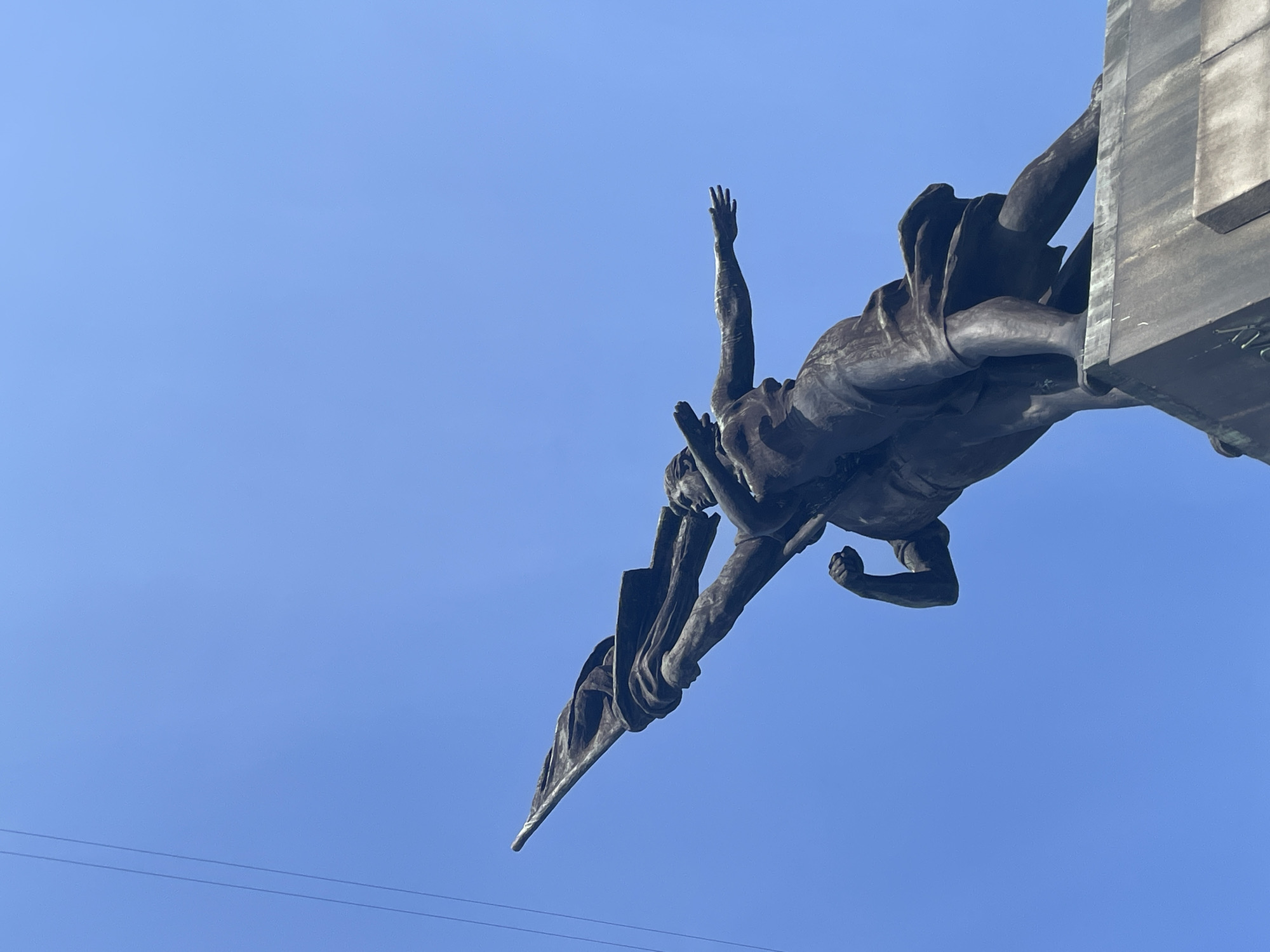 Bronze statue with raised arm photographed in Yekaterinburg