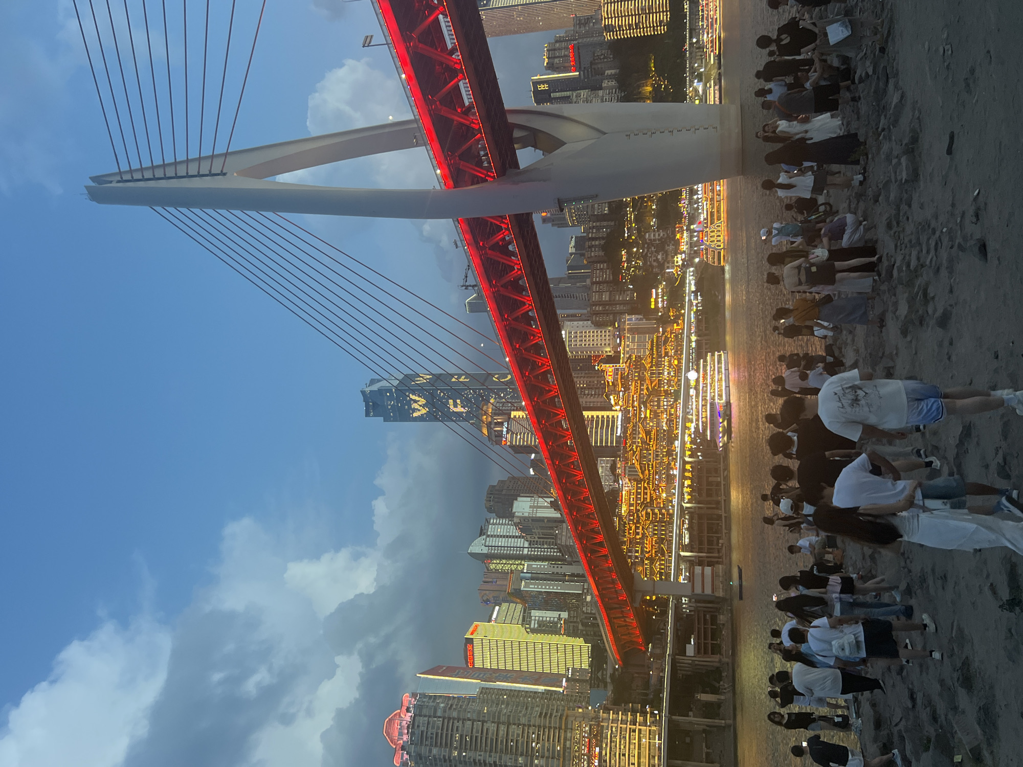 Chongqing's red-lit bridge and riverfront at dusk