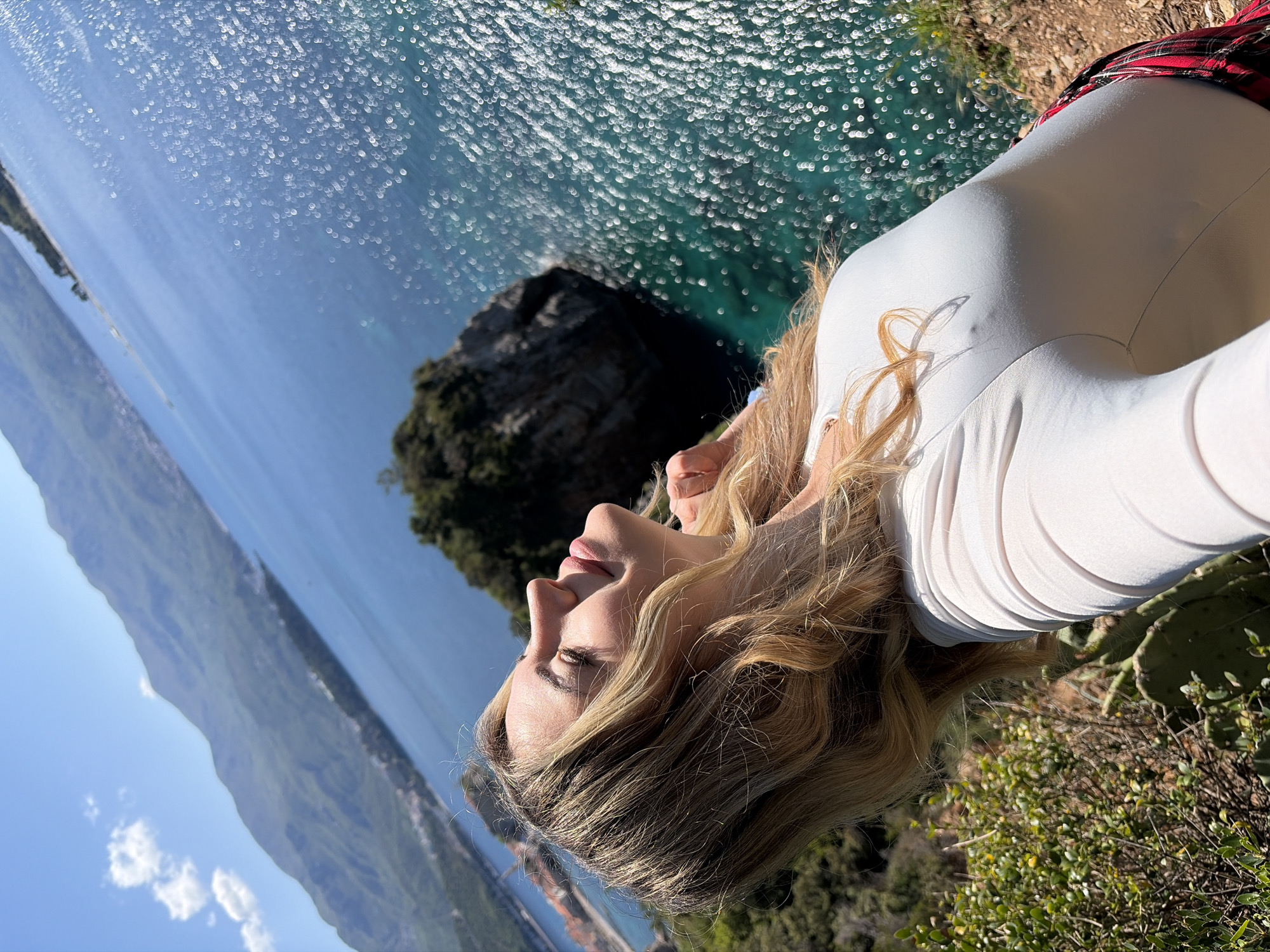Tourists capture scenic moments at Budva cliffs and coastline