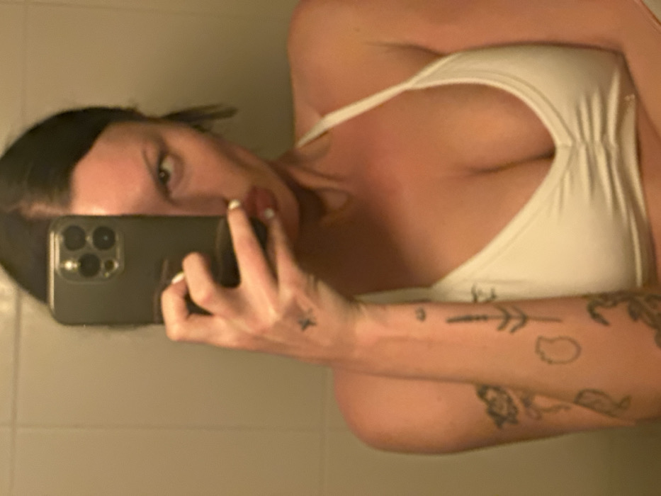 Woman takes mirror selfies in bathroom, Wealden UK
