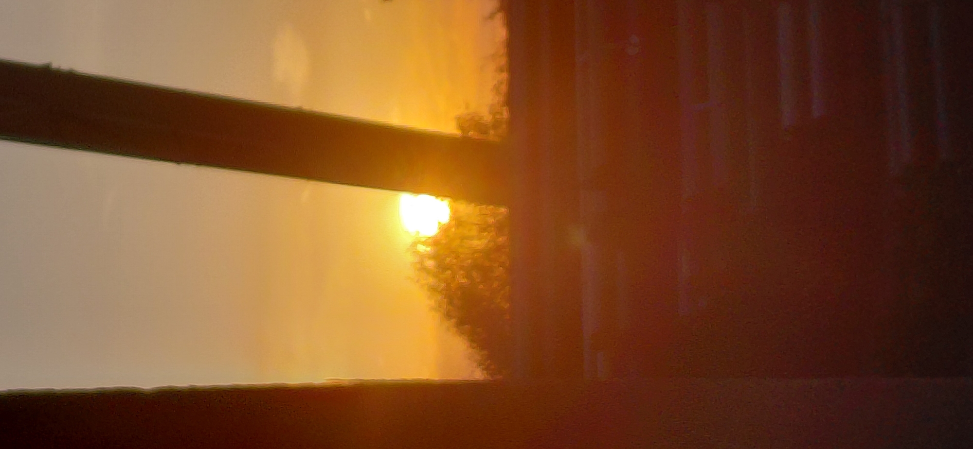 Sunset framed through glass and concrete at golden hour
