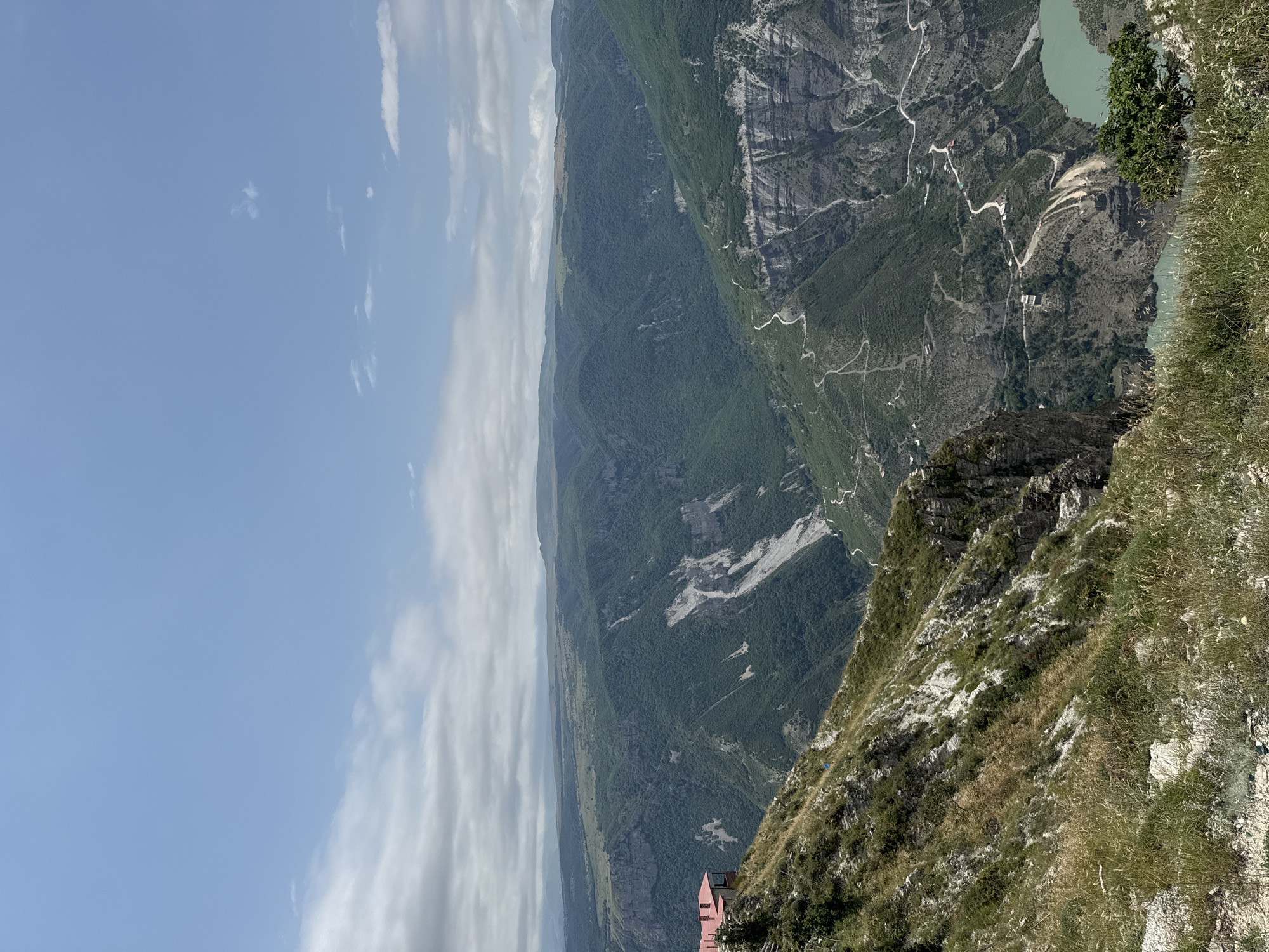 Green canyon and winding road cut through Russian wilderness