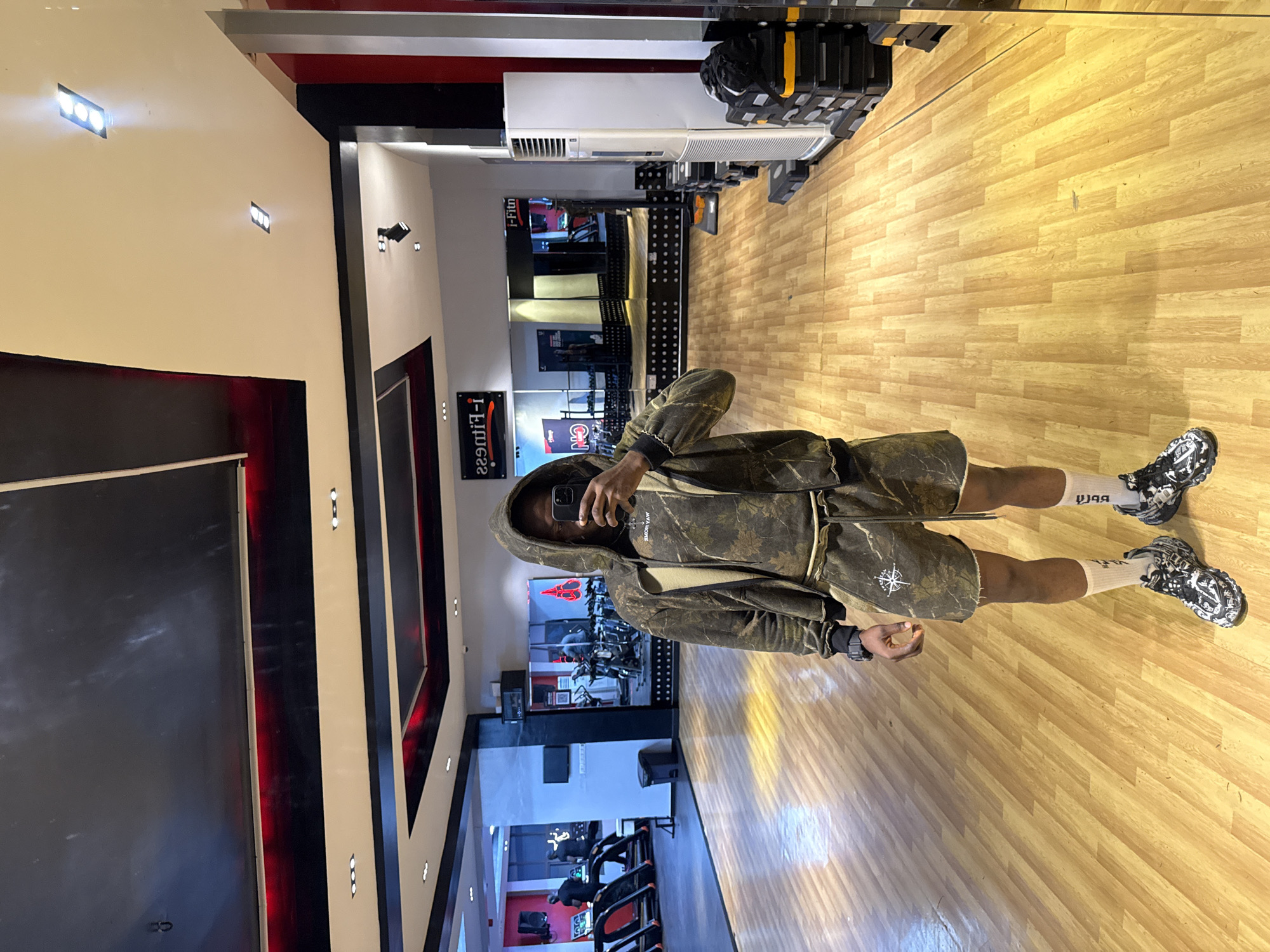 Gym mirror selfie in Lekki, camo fit.