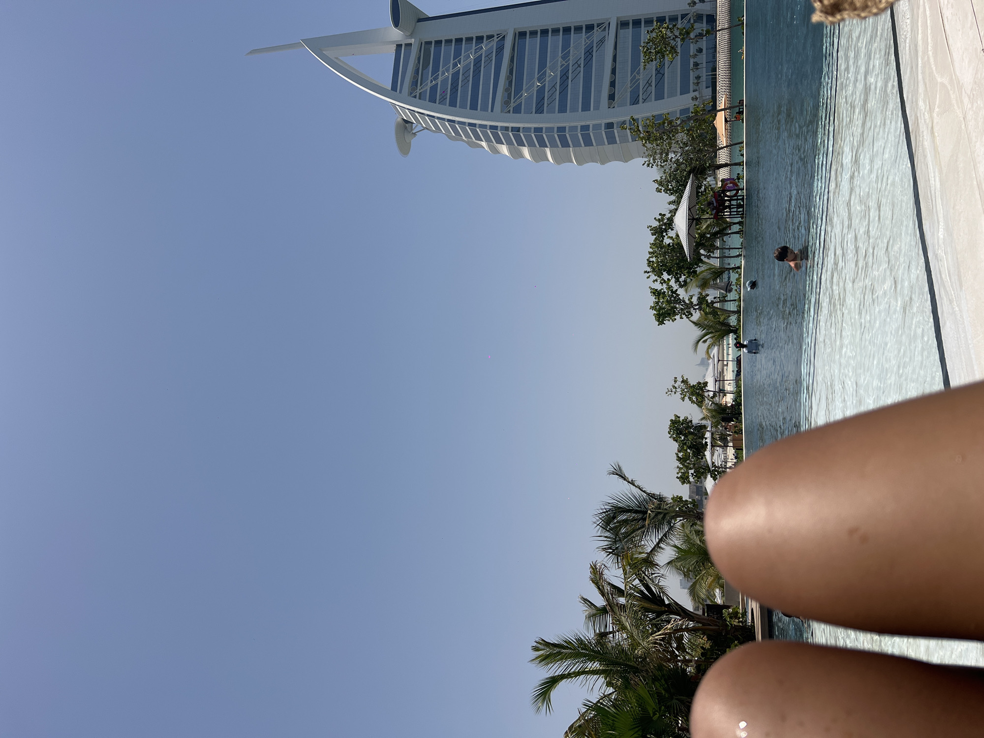 Morning swim captured at Dubai pool with Burj Al Arab backdrop