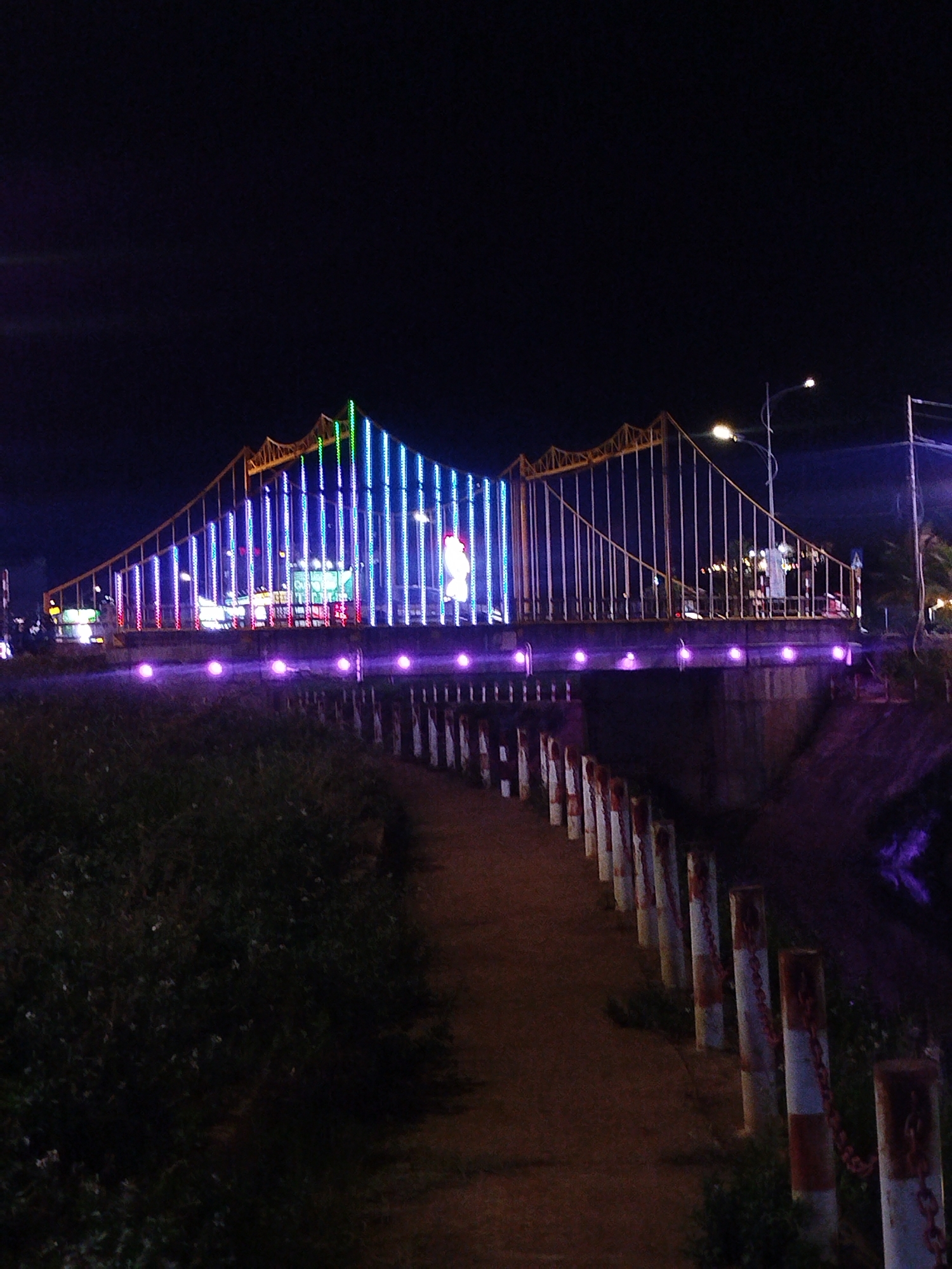 Illuminated bridge with colorful lights observed in Vietnam