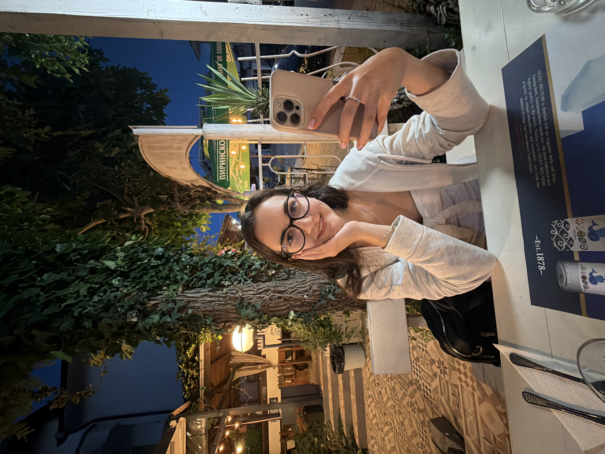 Outdoor dining in Kiten, phones out at the table