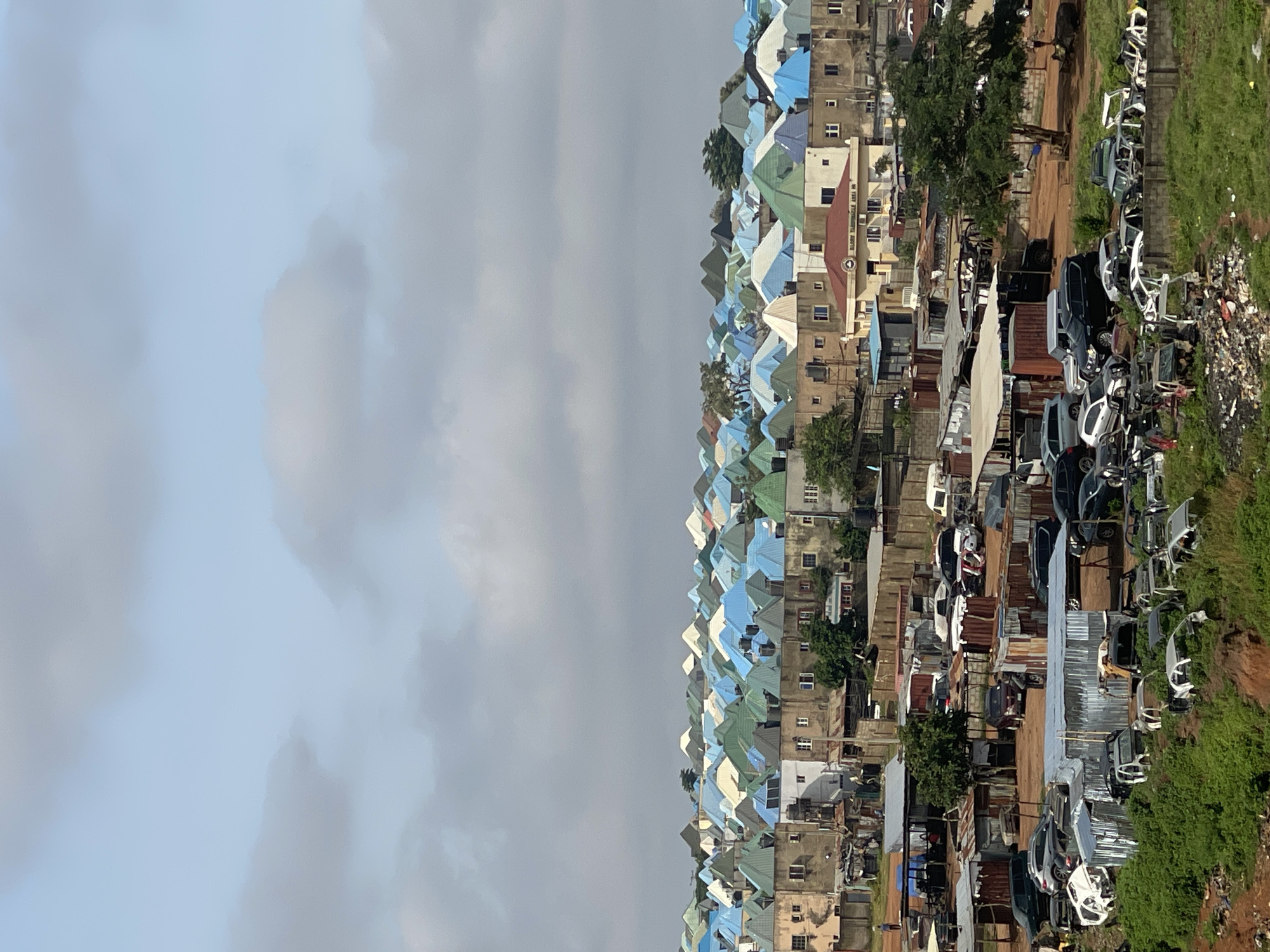 Abuja morning: city rooftops, modern homes, and street-level details