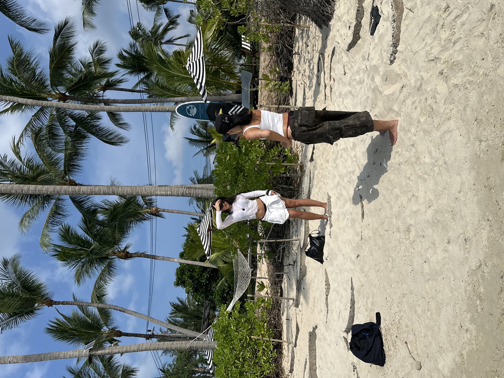 Two beachgoers enjoy sunny morning at Baan Tai, Thailand
