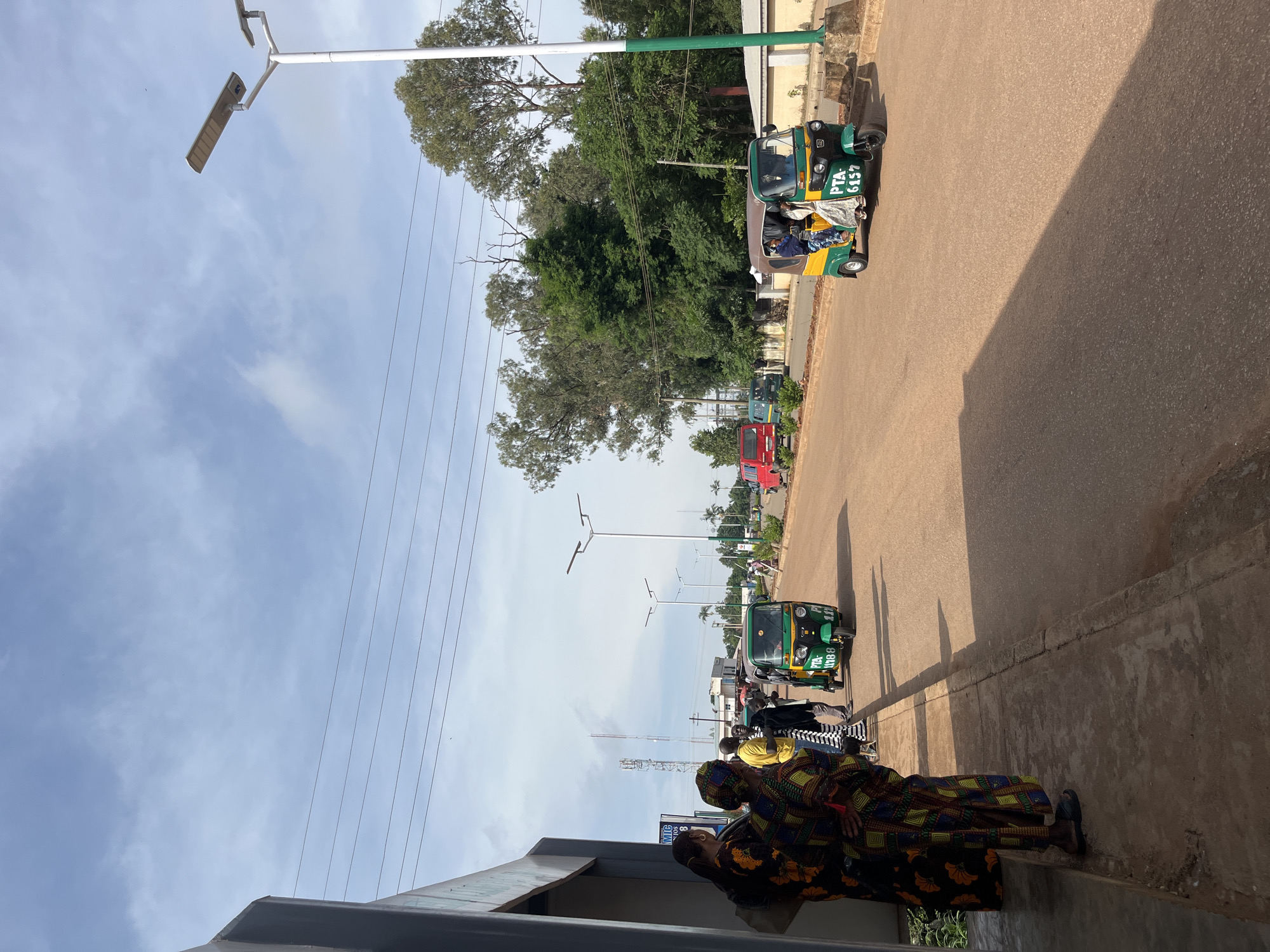 Morning street activity along a main road in Bukuru, Nigeria