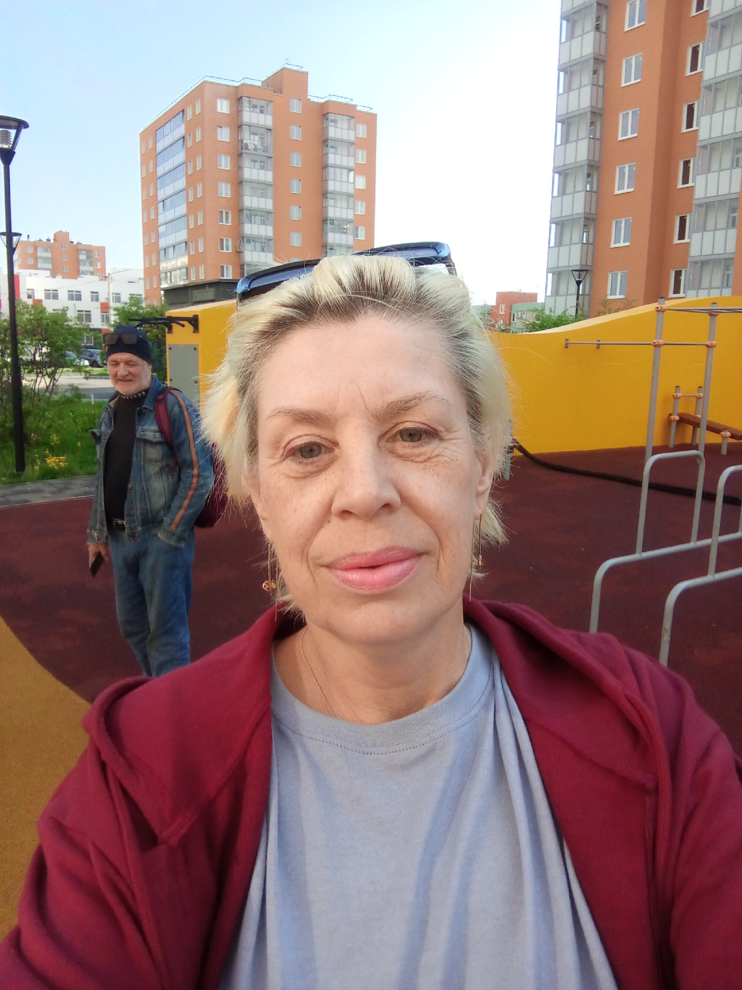 Couple photographs each other at Kommunar playground early morning