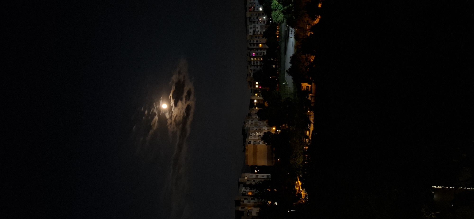 Quiet Sofia night: moon, streetlights, and a stairwell window