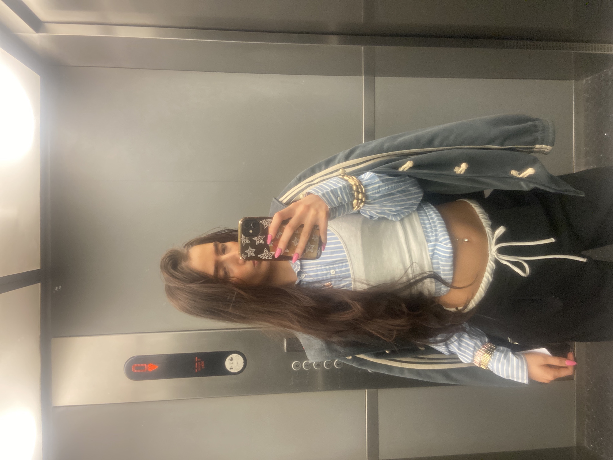 Woman takes selfies in London elevator