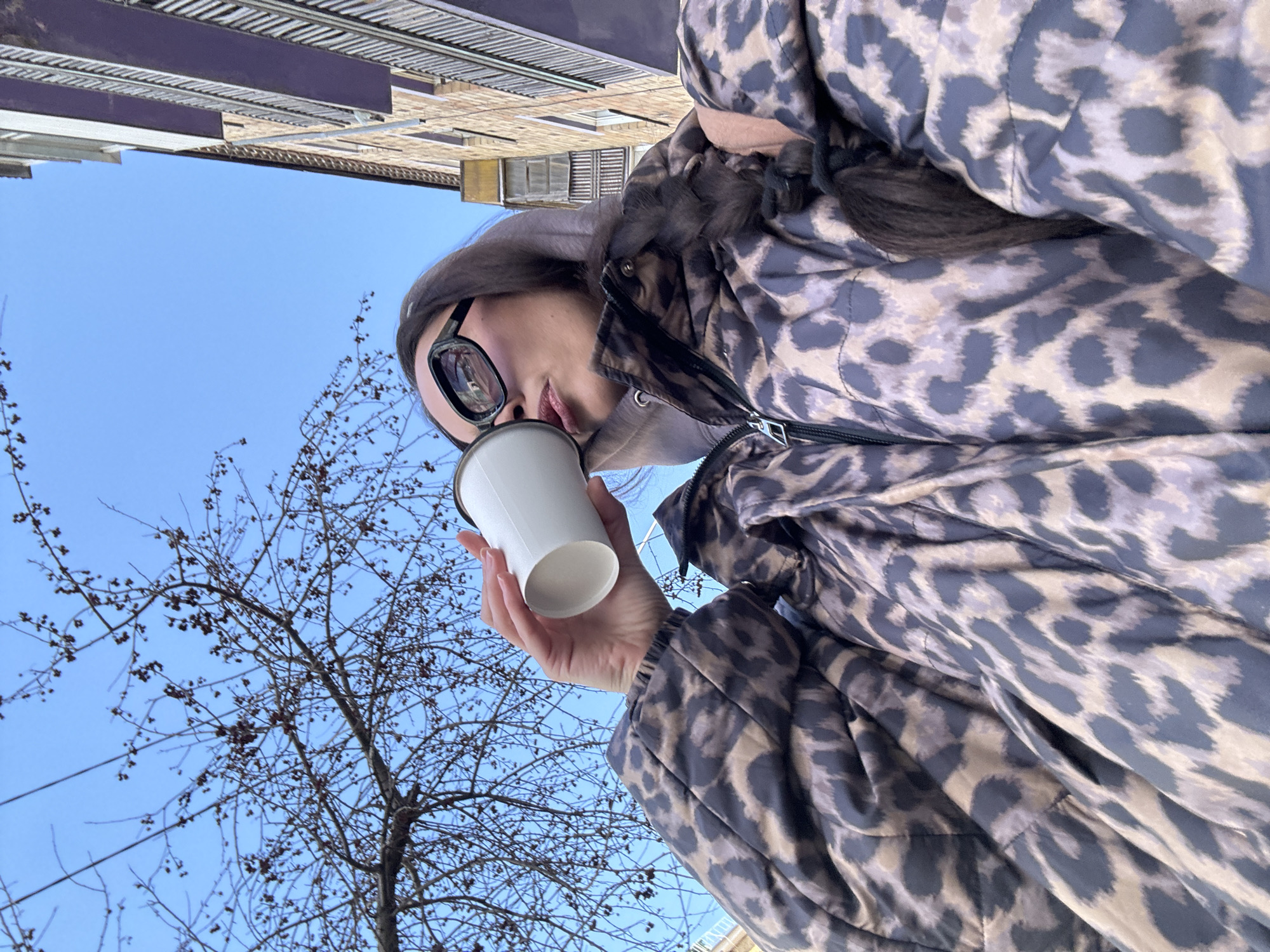 Woman enjoys morning coffee by Yenisey River in Krasnoyarsk