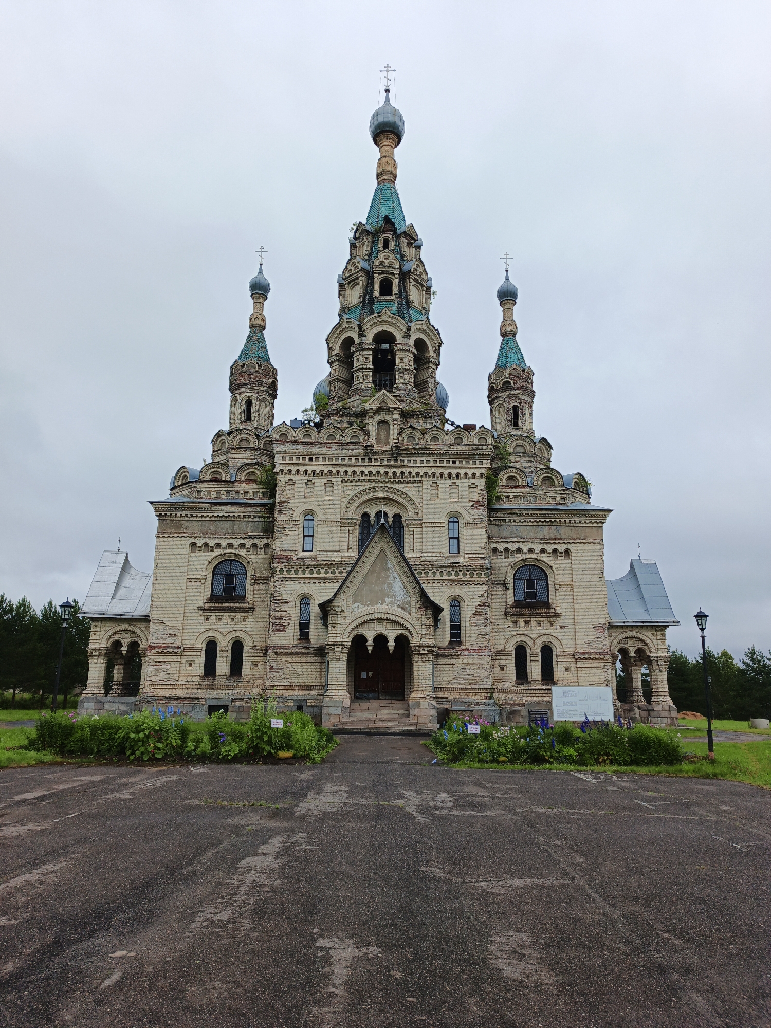 Ornate Orthodox church with domes and bell towers under gray skies