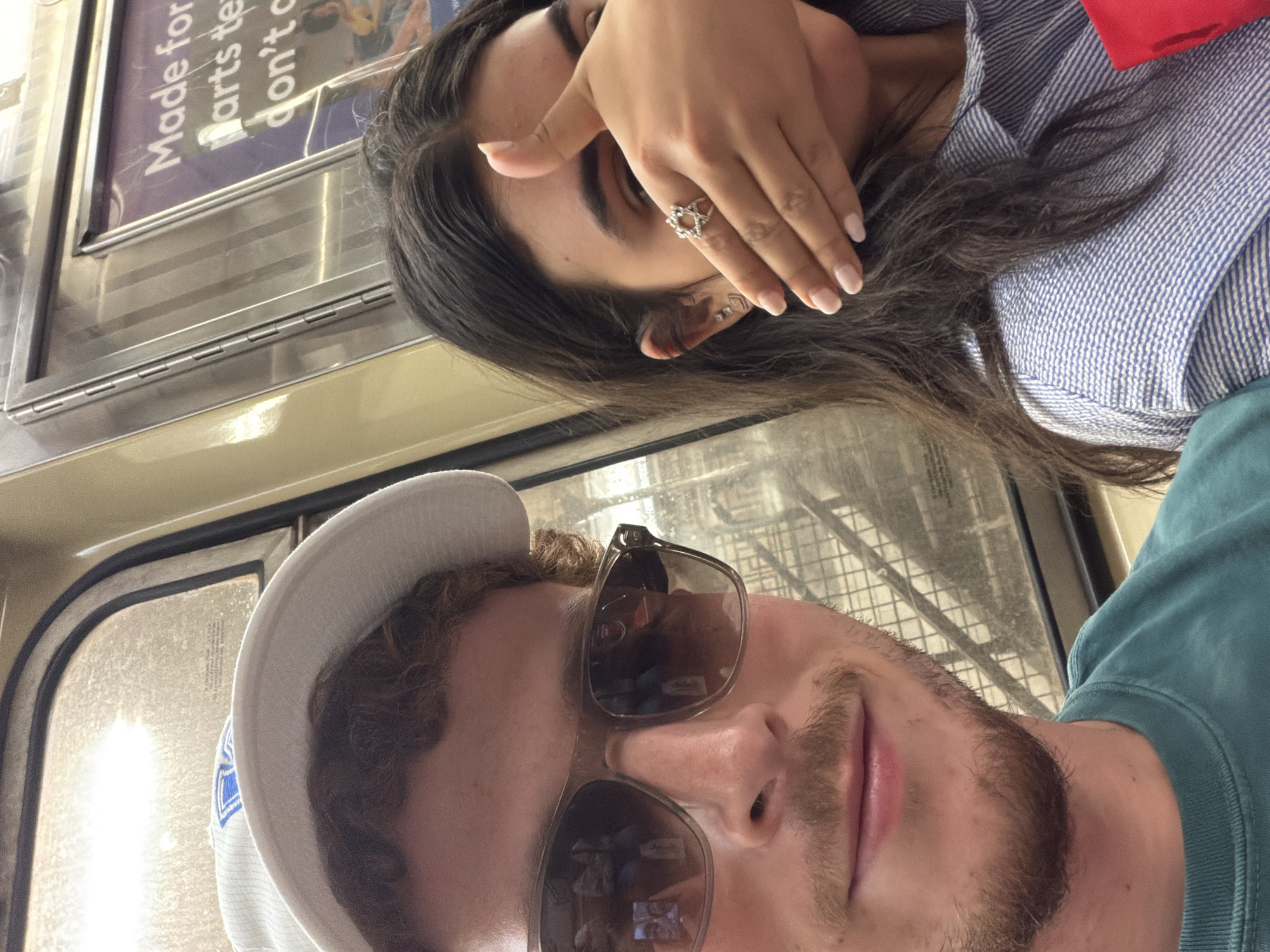 Couple Takes Playful Selfies on NYC Subway Train