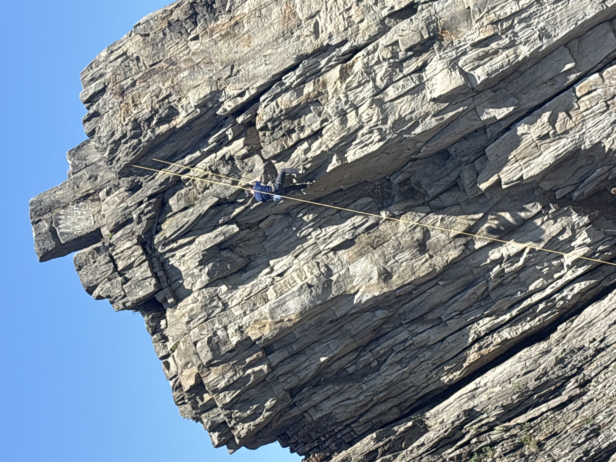 Rock climbers practice on coastal cliffs near Vladivostok beach