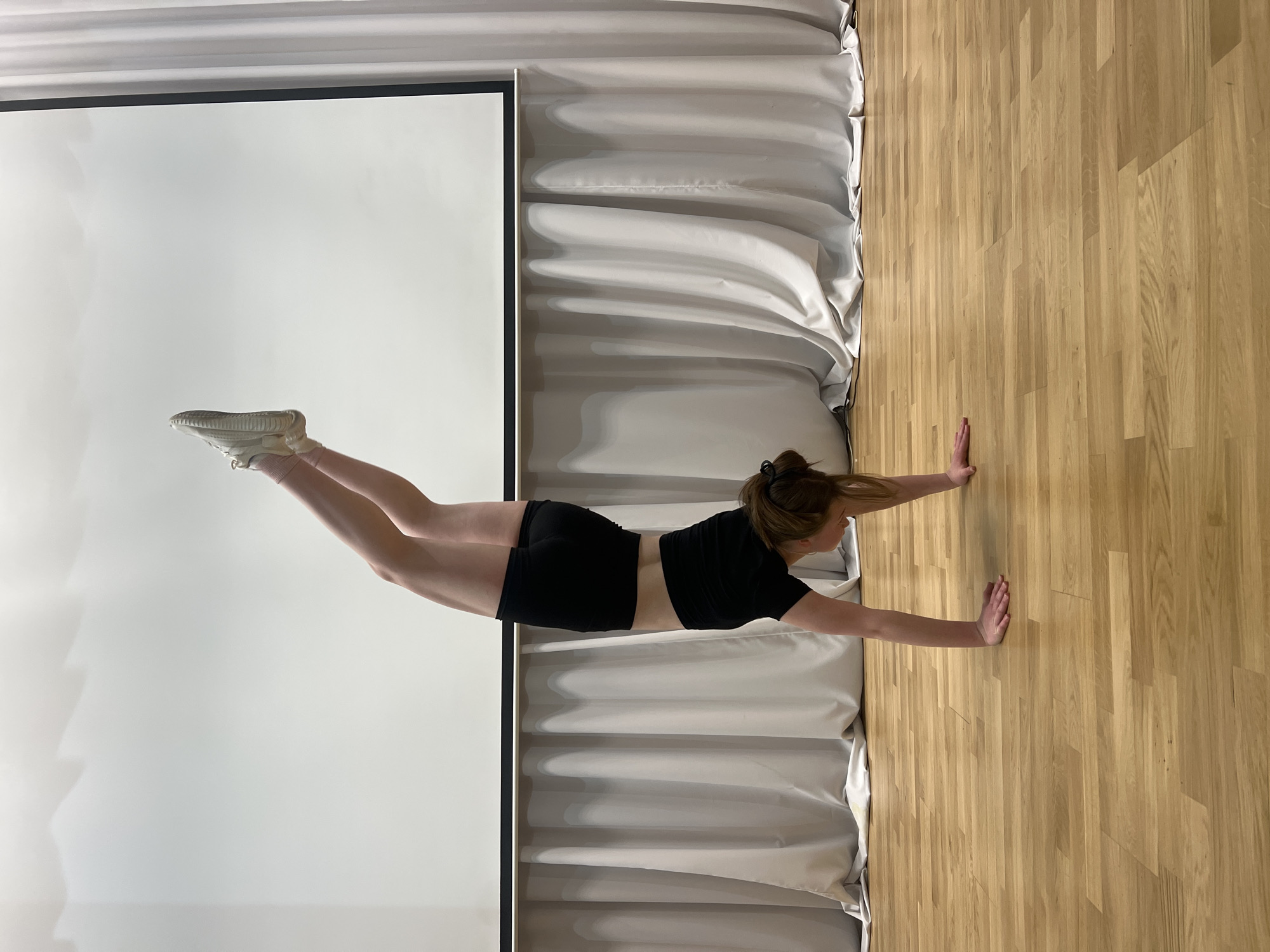 Woman performs wall plank exercise in Chaikovsky, Russia