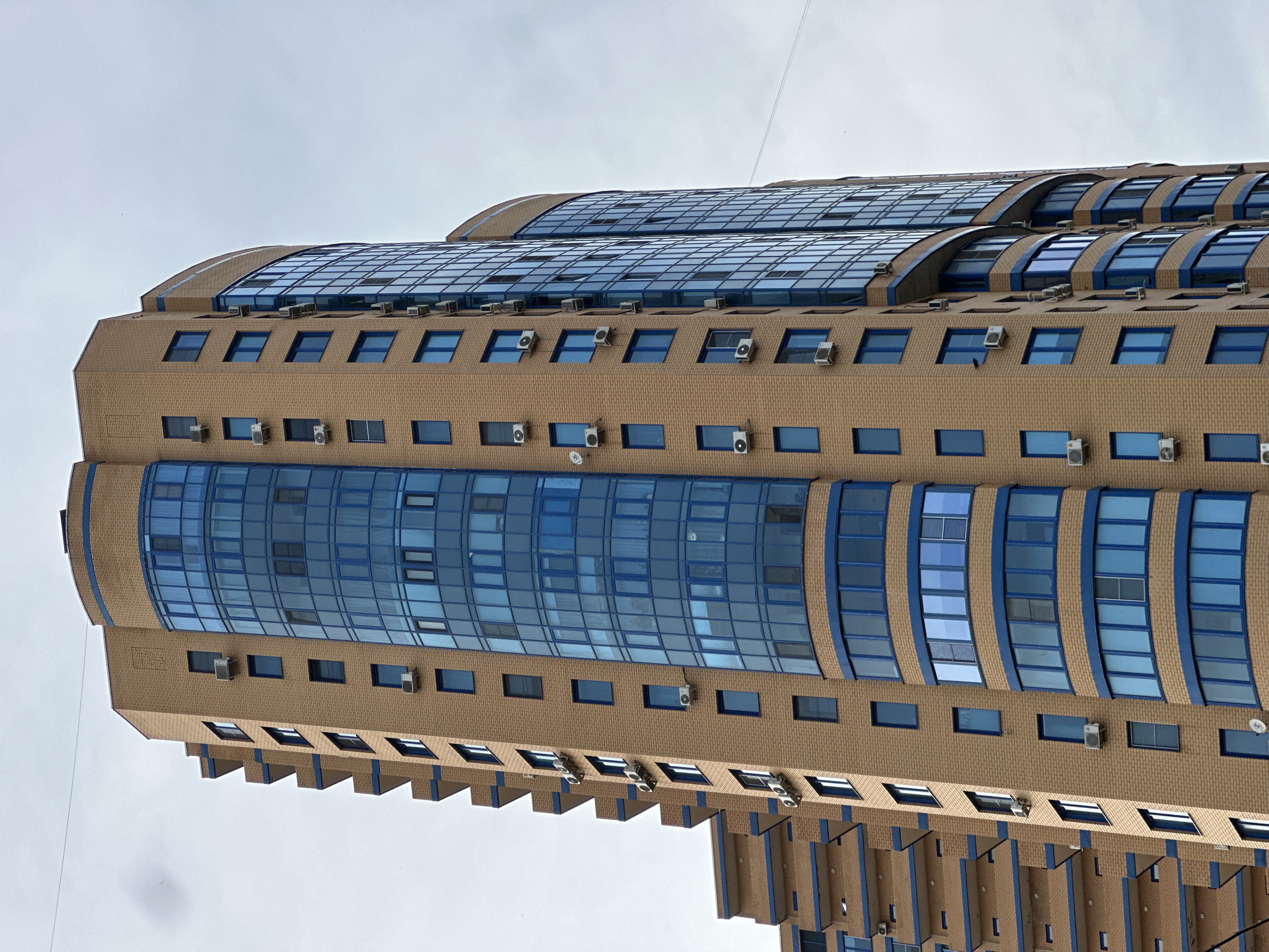 Modern building with blue glass facade observed in Reutov