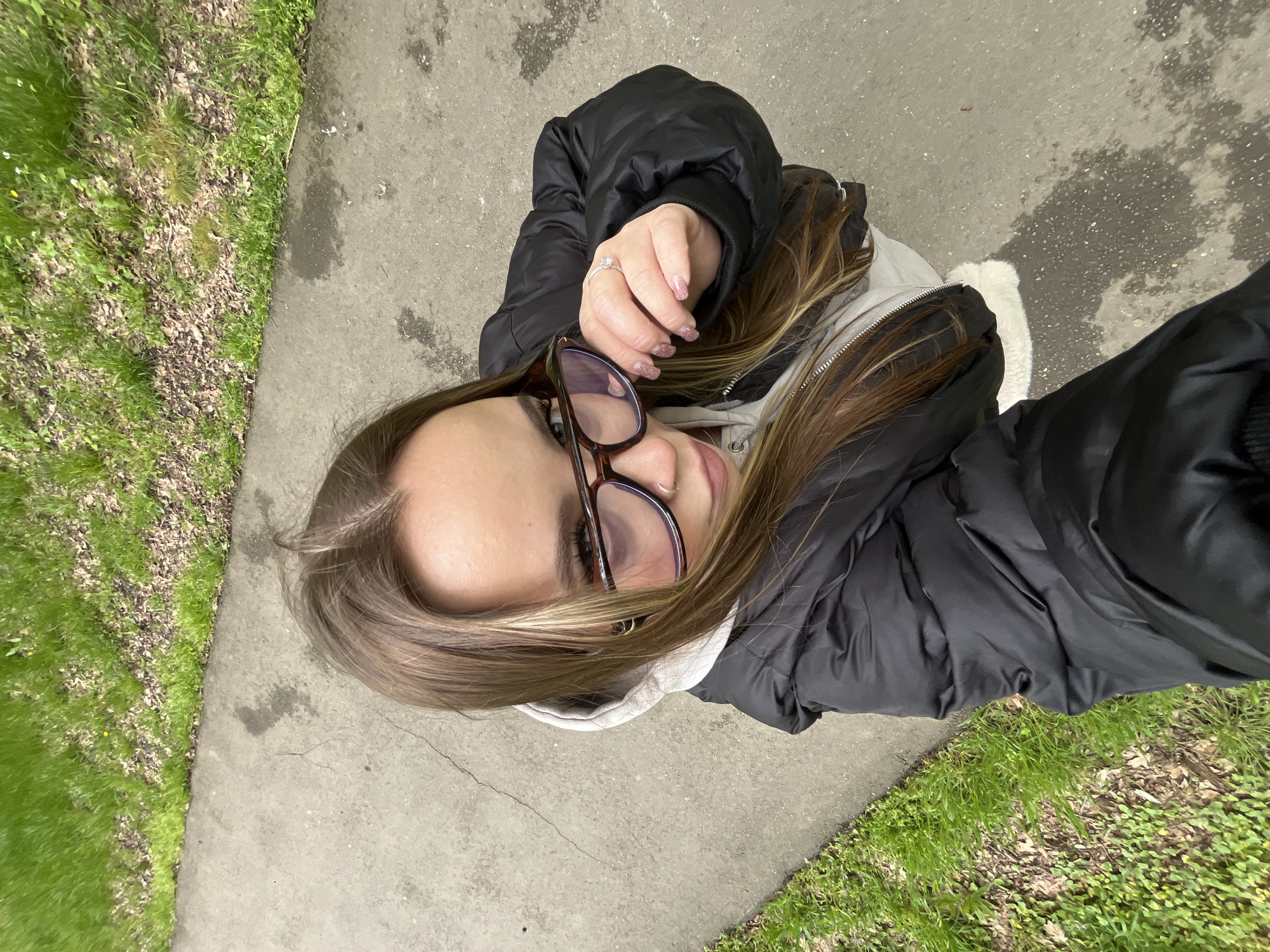 Woman poses for selfies in Krasnodar park during spring outing