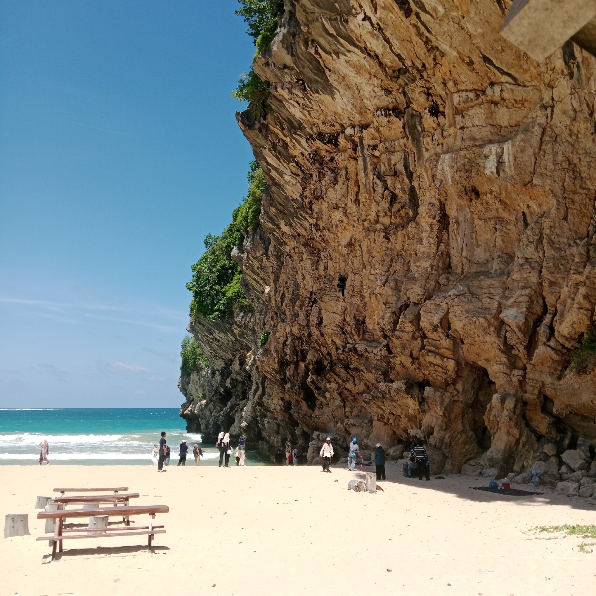 Rappelling and beachside relaxation at a clifftop coast in Indonesia