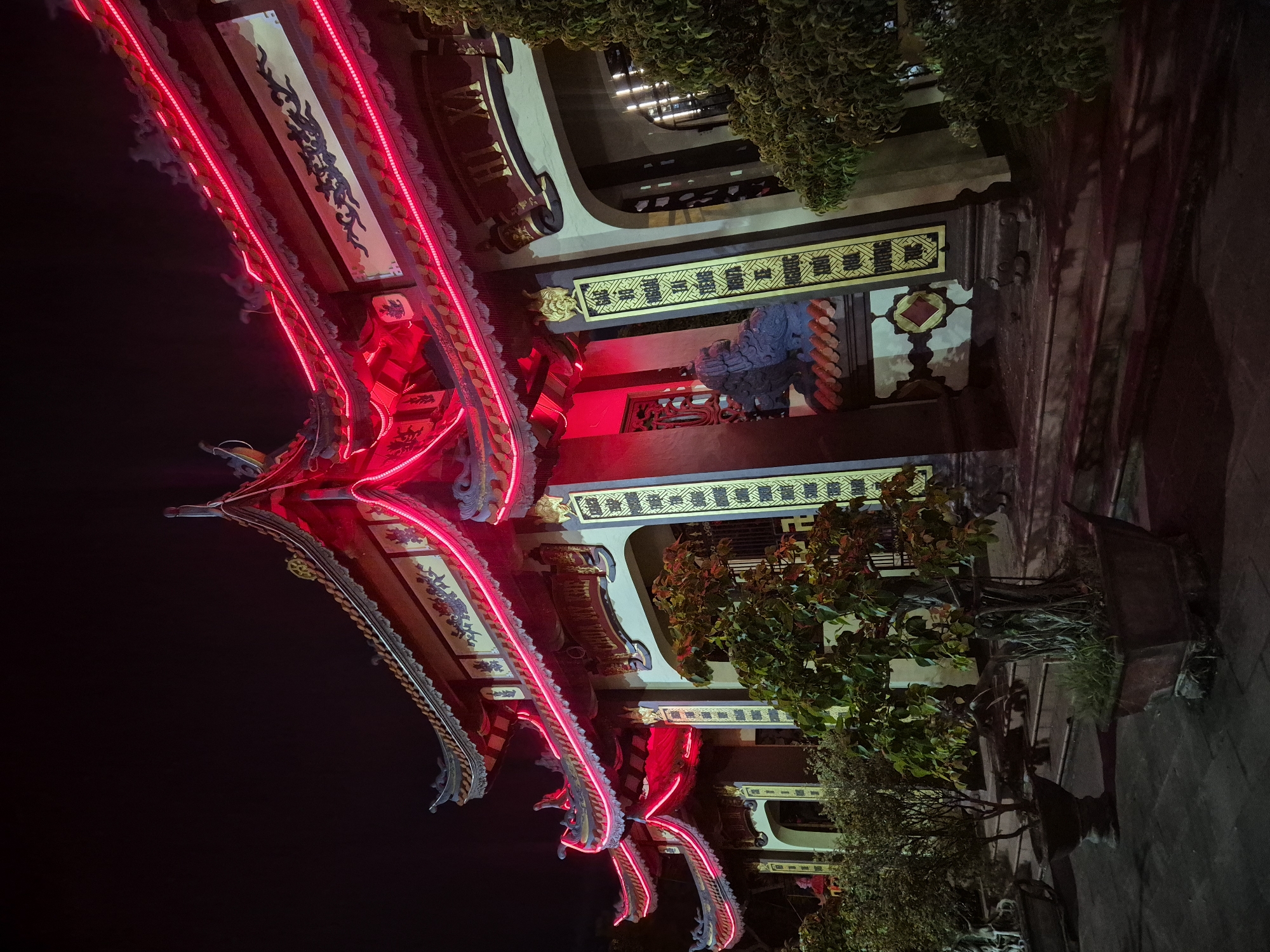 Nighttime temple complex in Đà Nẵng lit up with neon and lanterns