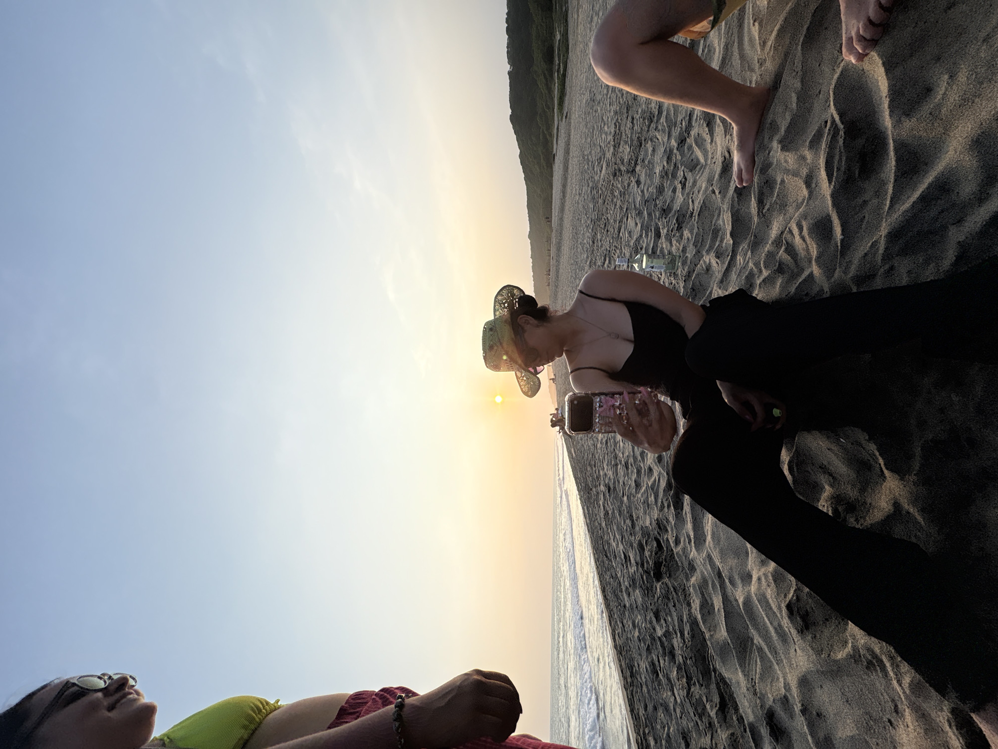 Sunset beach moment in Puerto Escondido, phone in hand.