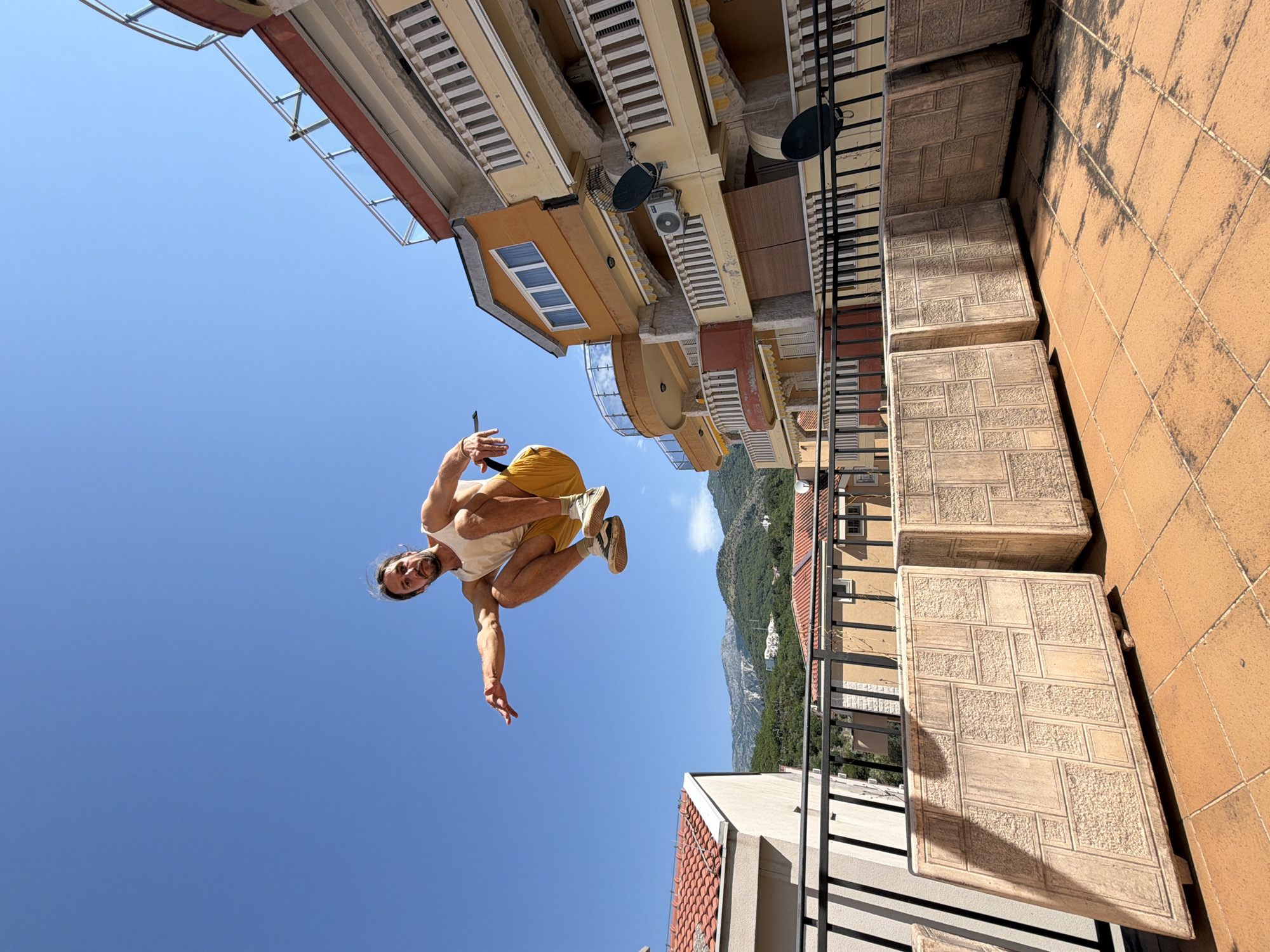 Parkour athlete performs rooftop jumps in Pržno, Montenegro
