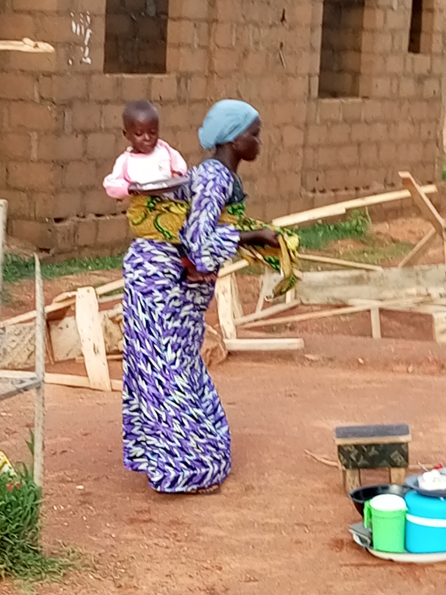 Baby carried on back in Tumfure, Nigeria
