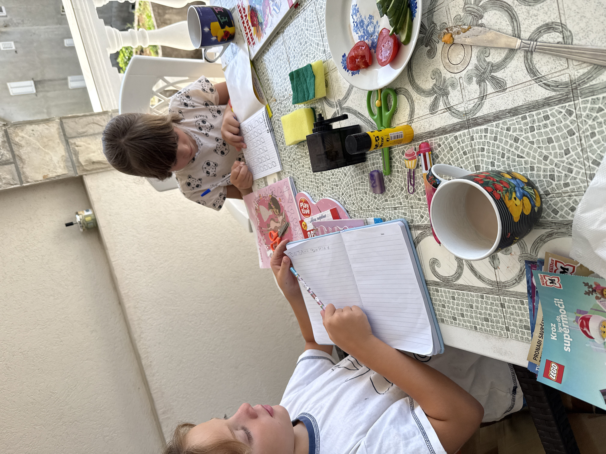 Morning moments captured in Bijela: children drawing, woman photographed