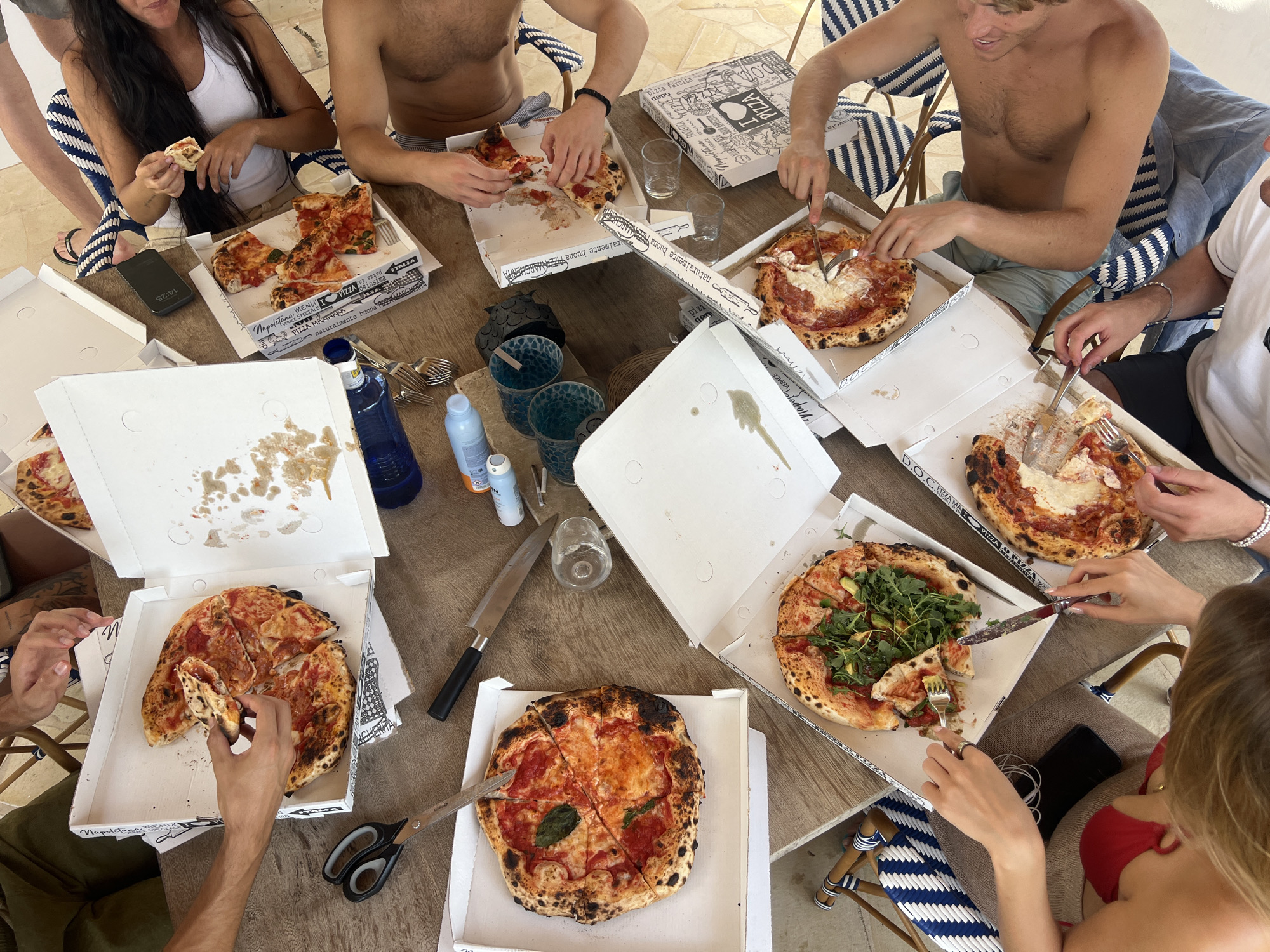 Outdoor pizza lunch on a rustic patio in Spain