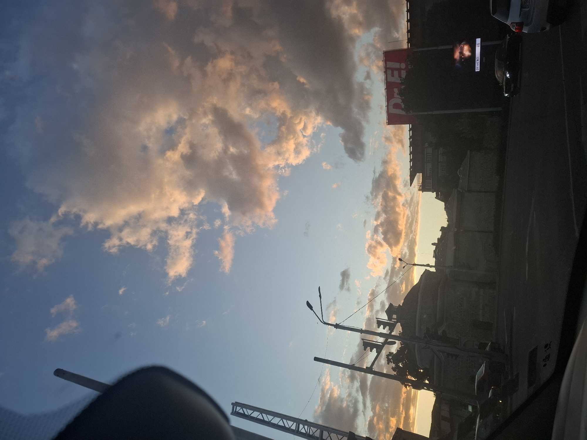 Urban sunset with dramatic clouds and street views