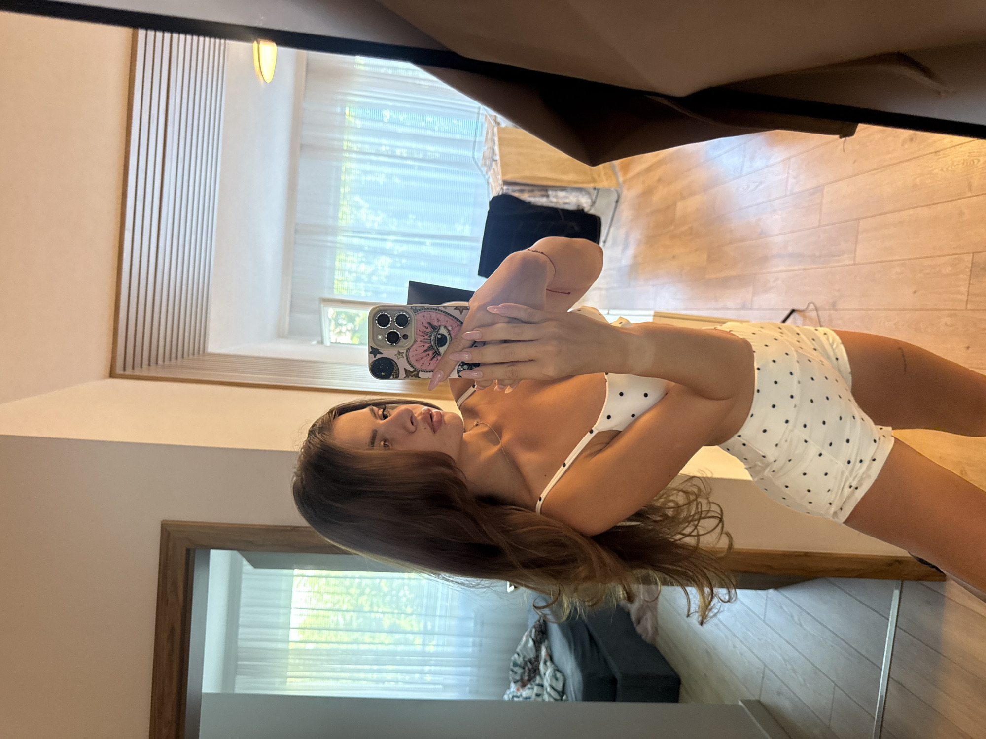 Woman photographs herself around Plovdiv in polka dot outfit