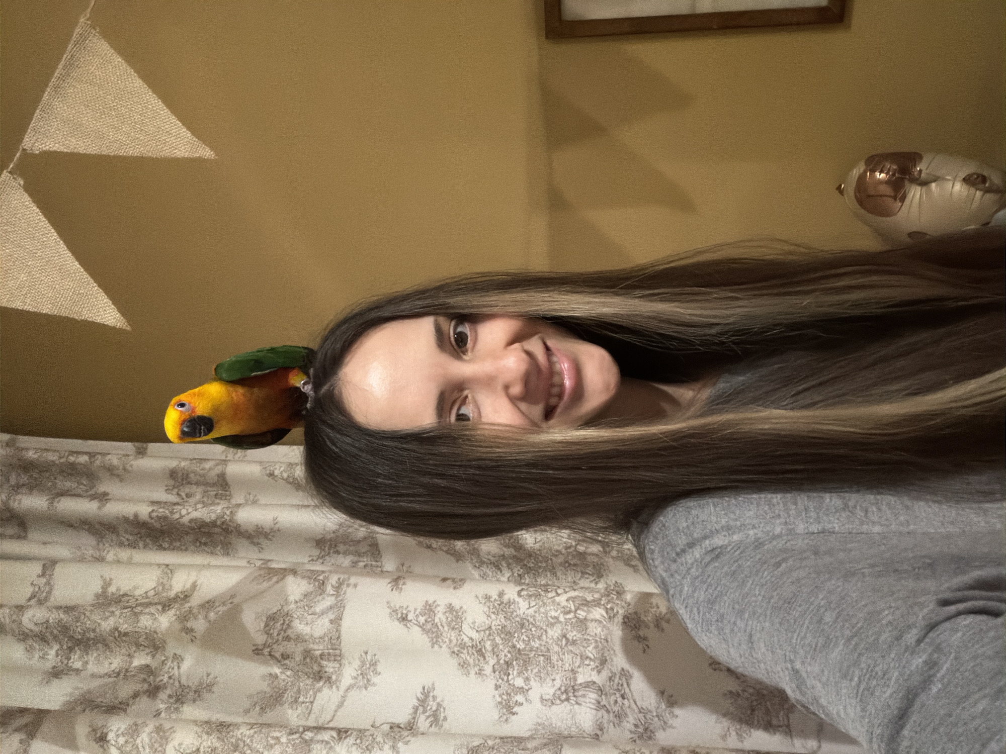 Woman photographed smiling with parrot perched on head in Khimki