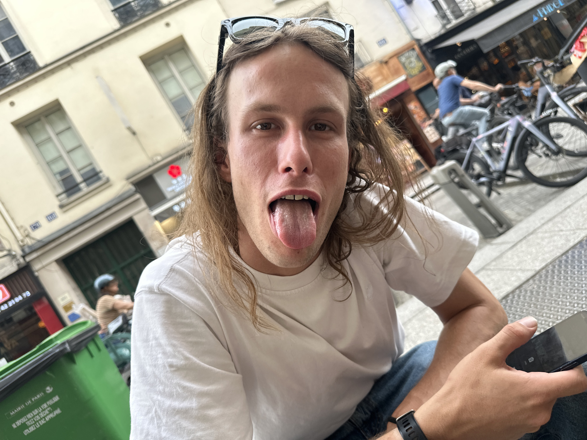Tourists take selfies at Paris street cafe