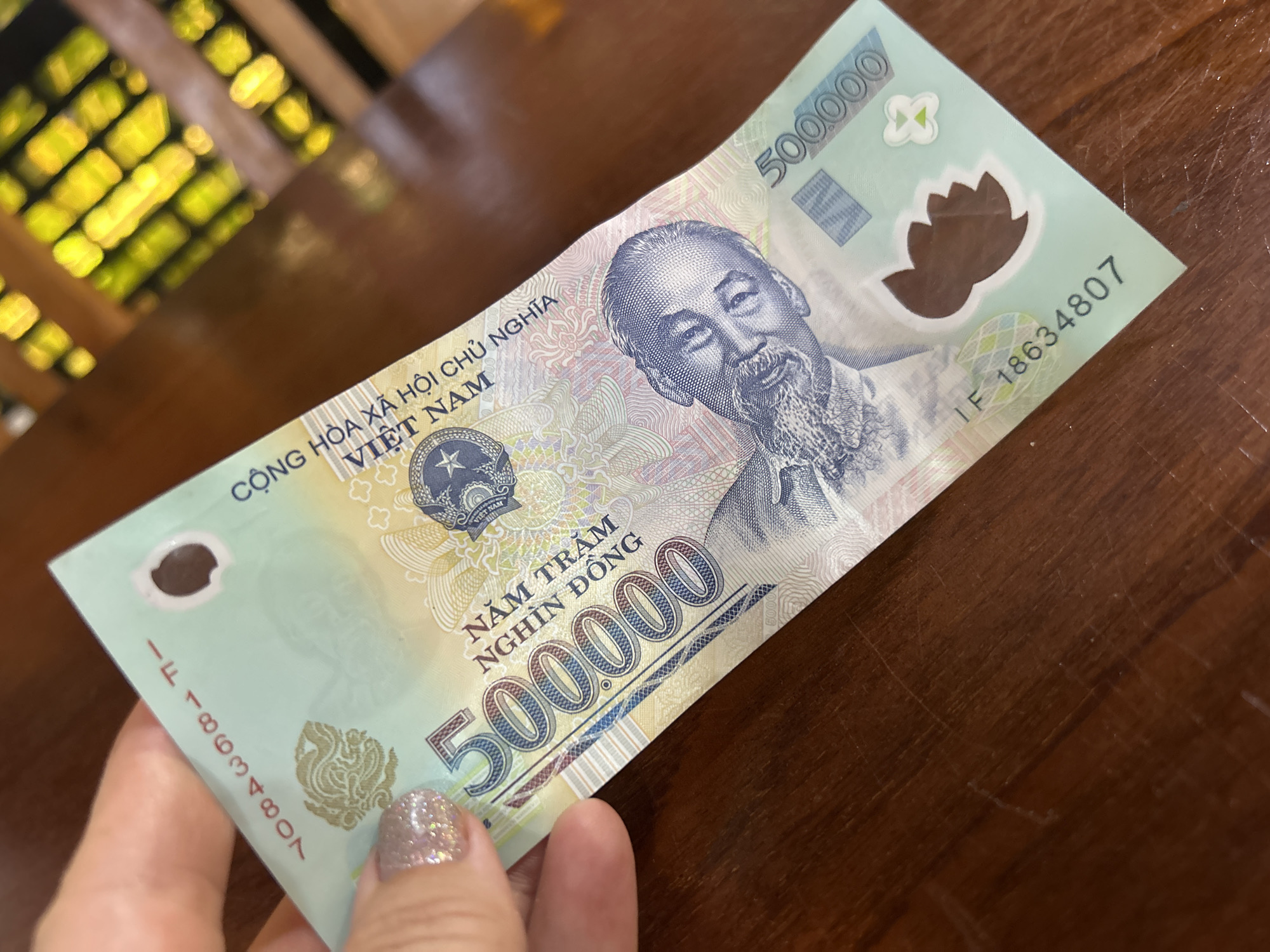Lunch and currency documented at Nha Trang café