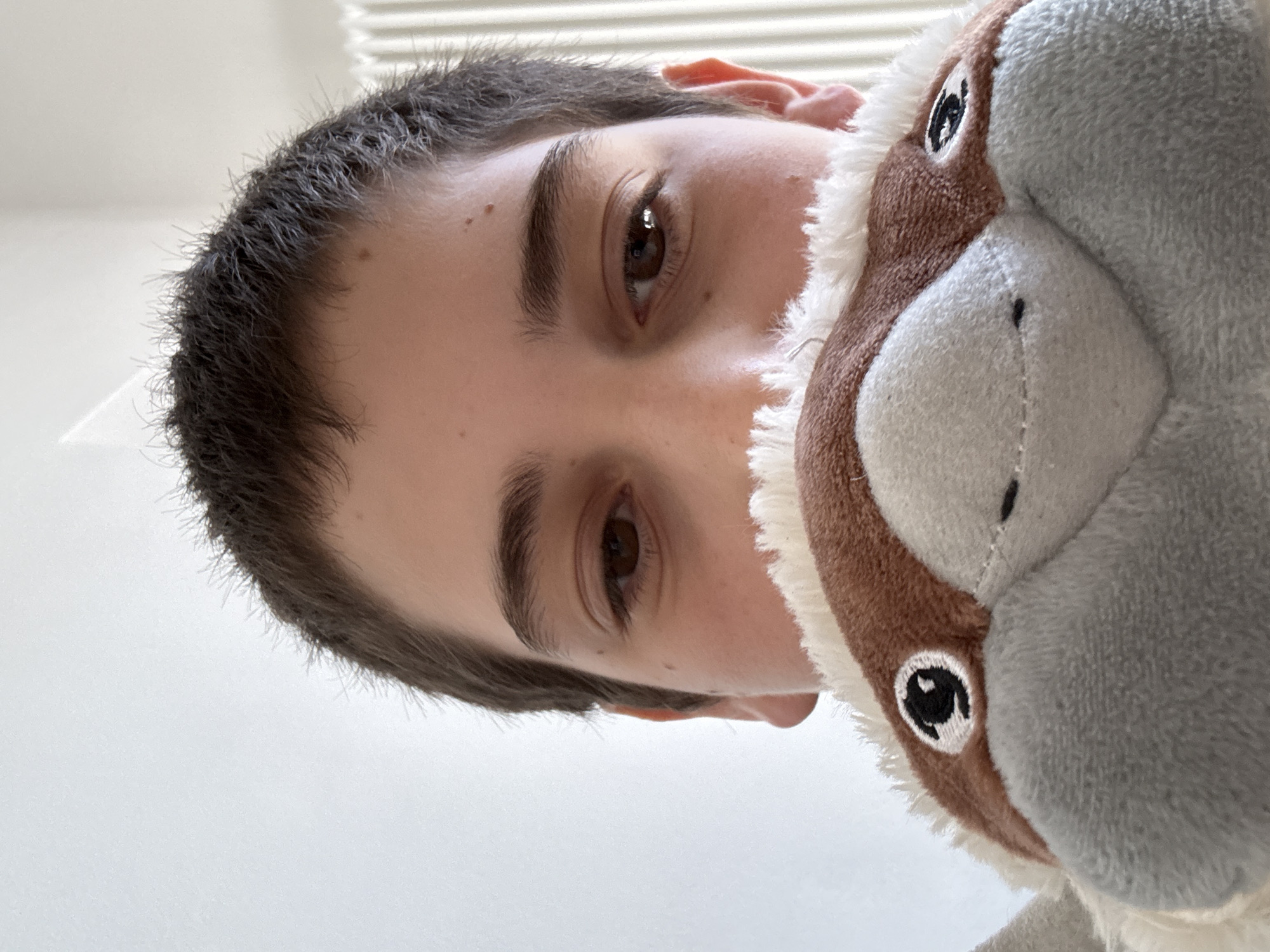 Person photographed with stuffed animal in Erba, Italy